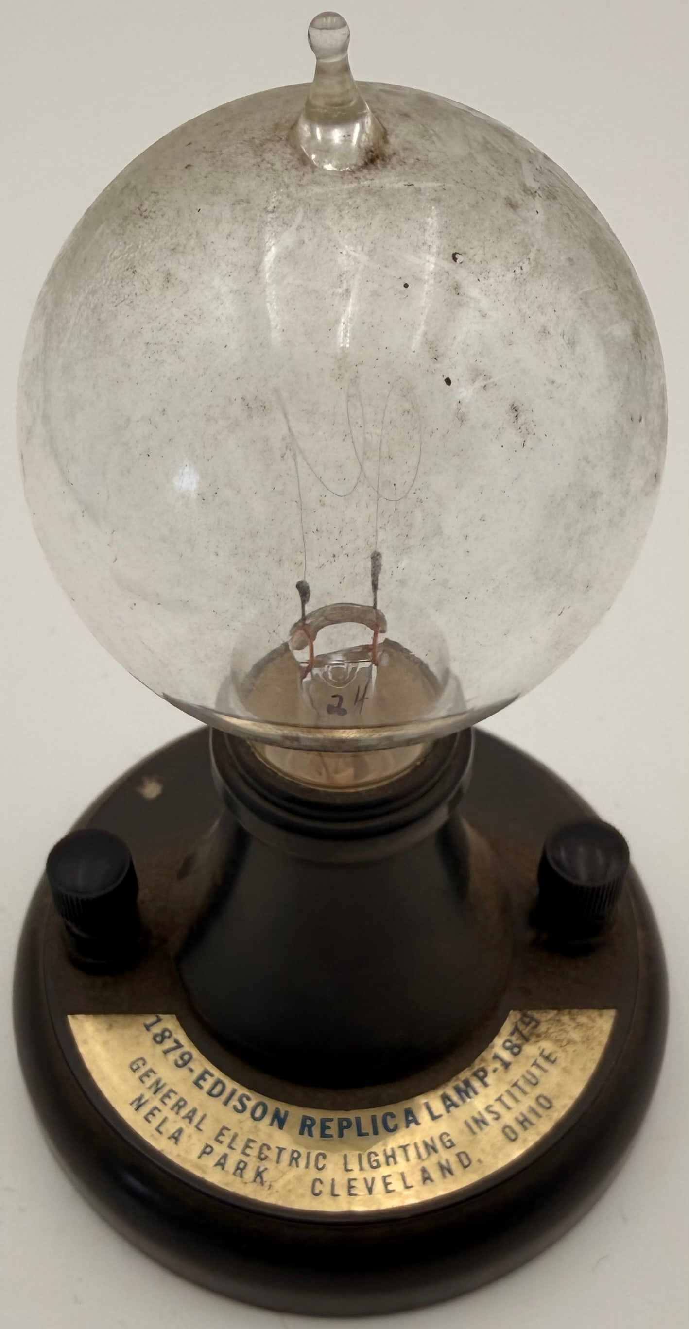 GE Nela Park Edison Replica Lamp Vintage: Vintage General Electric Lighting Institute Edison replica lamp, produced as a commemorative or souvenir piece for Nela Park. Dating to approximately the 1950s–1970s, this display lamp features a cl