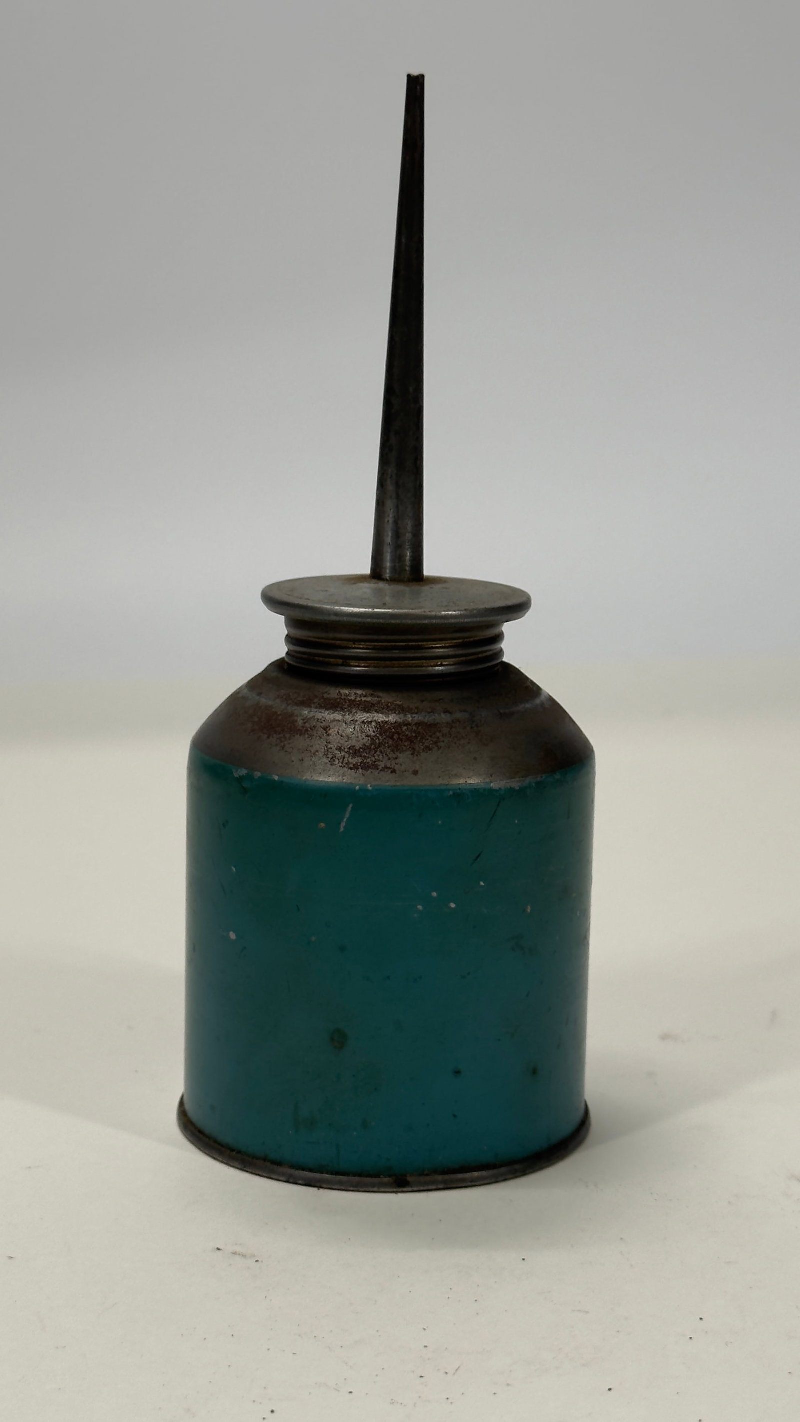Vintage Teal Steel Pump Oil Can w/ Long Spout: Vintage steel pump oil can featuring its original teal-painted body, threaded cap, and long tapered spout. Designed for precision lubrication of machinery, electric motors, and shop equipment. Display