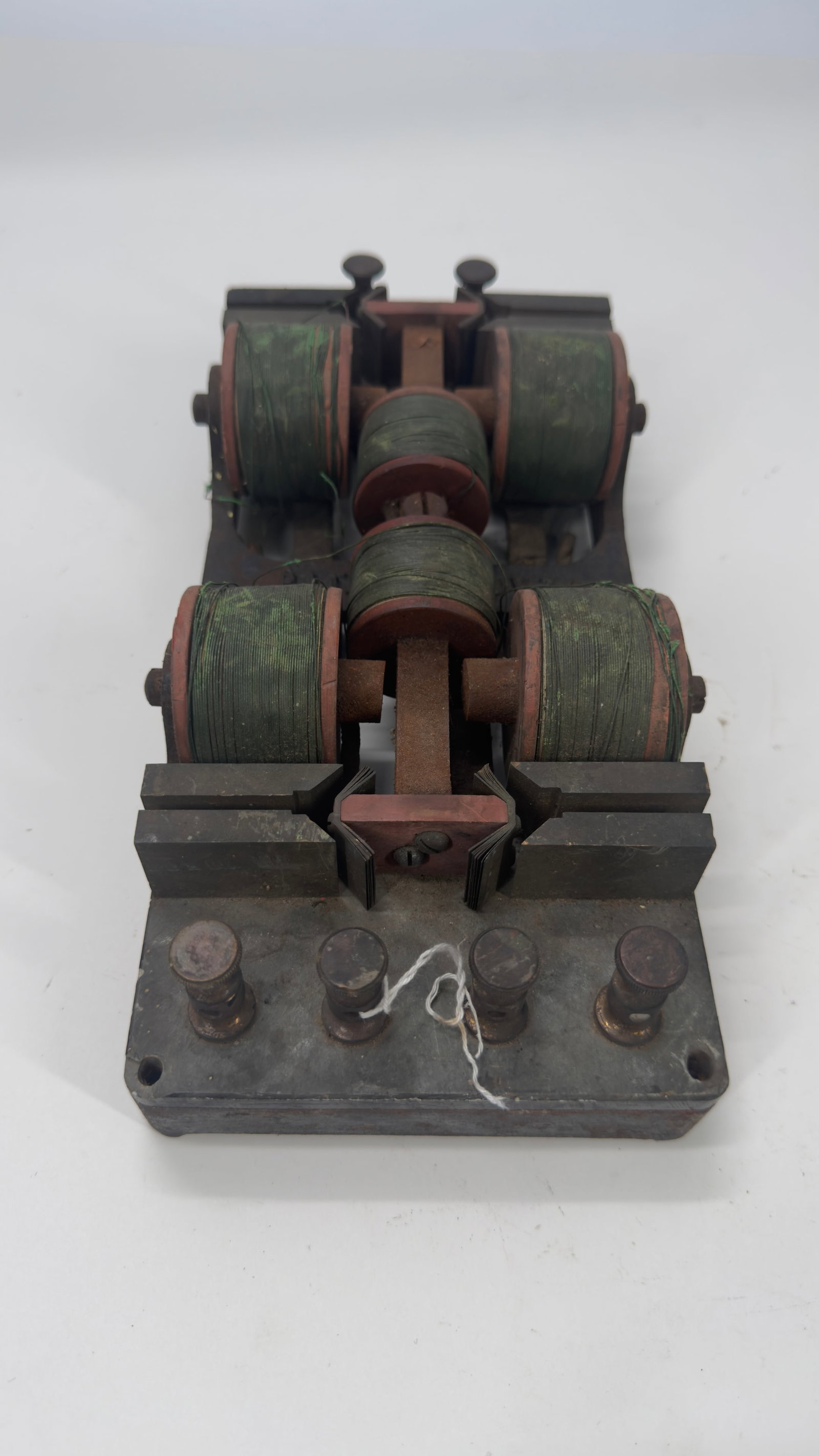 Antique Electromagnetic Knife Switch Assembly c. 1890–1910: Antique electromagnetic knife switch or relay assembly featuring four original copper-wound coils, laminated iron cores, and heavy brass terminals mounted on a cast iron base. Used in early electrical