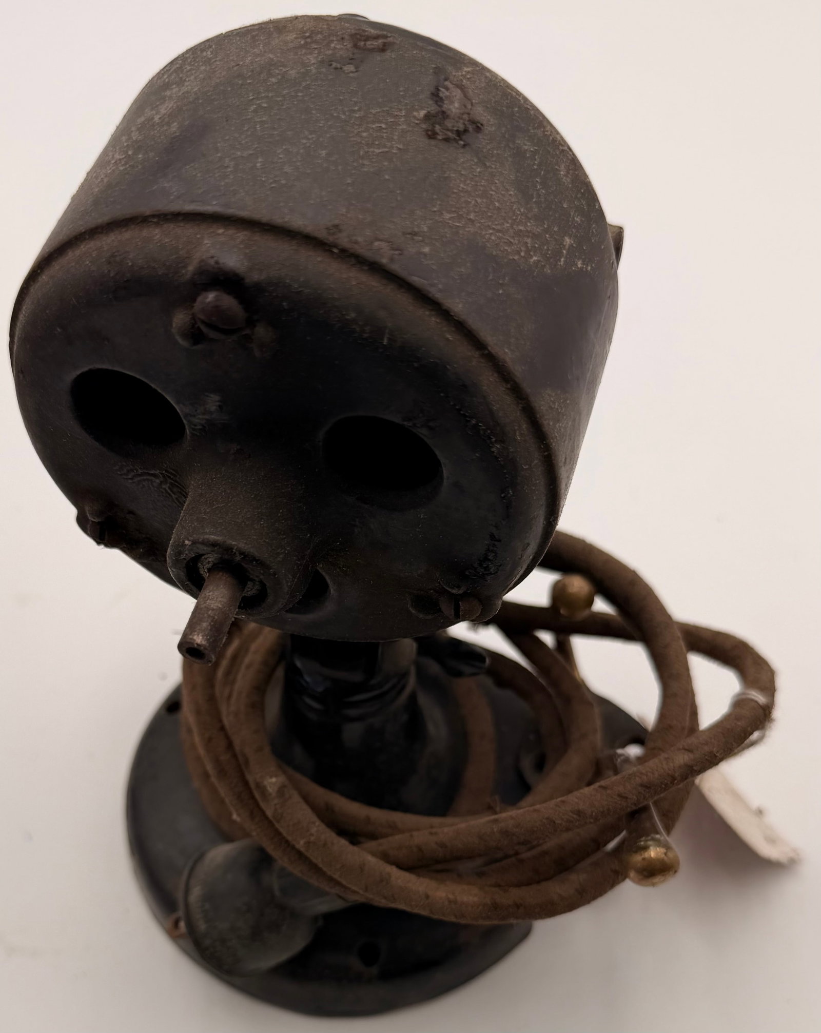 Antique Cast Iron Electric Fan Motor Housing: This antique electric fan motor housing is constructed from heavy cast iron and features a vintage ball-joint head design commonly found on early table and industrial electric fans. The housing repres