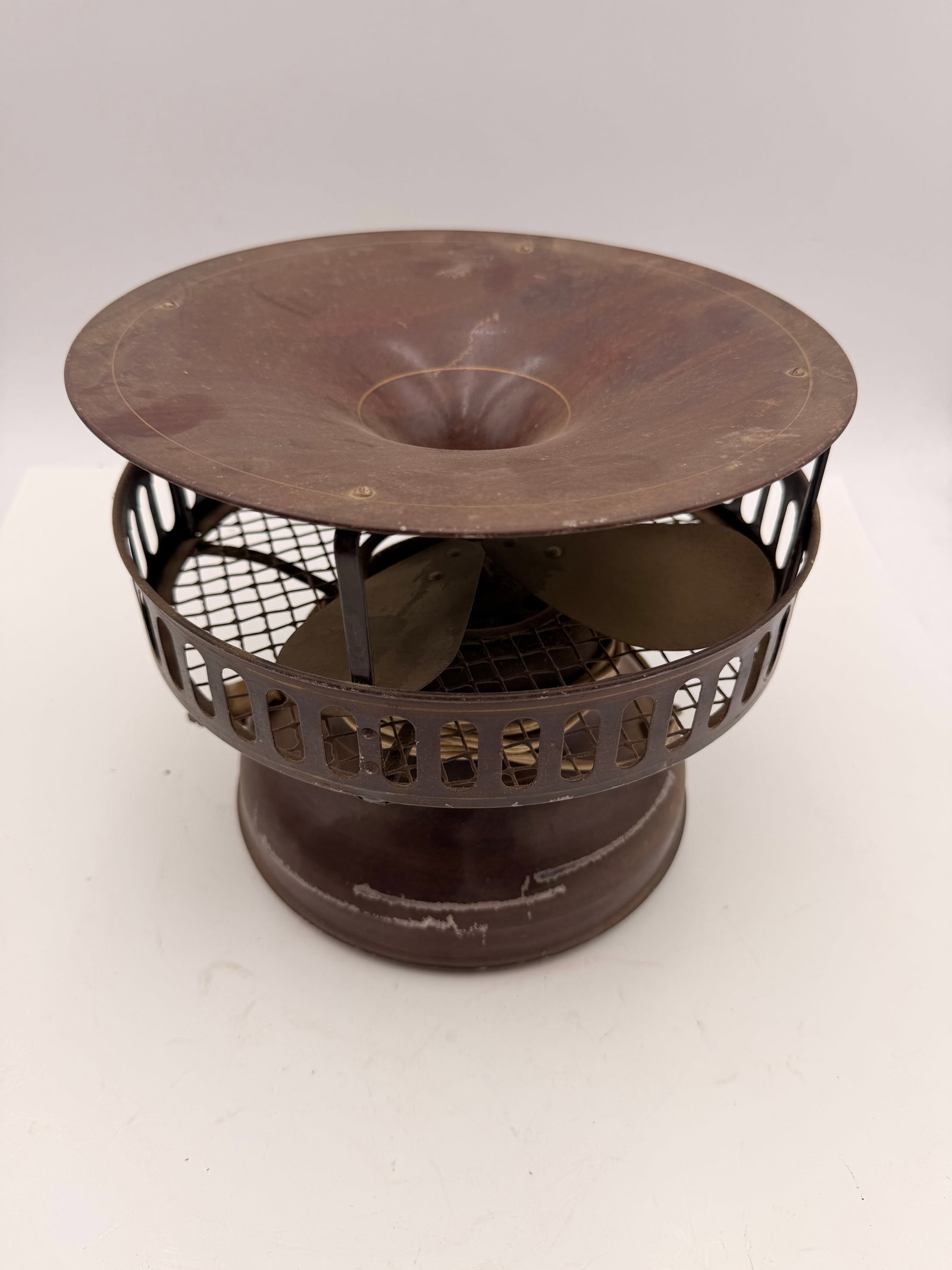 Antique Electric Ventilator Air Circulator Fan c.1910–1925: Antique electric air circulator/ventilator fan dating to the early 1900s. Features a four-blade brass fan enclosed within a decorative steel housing topped by a wide conical air diffuser. Designed to 