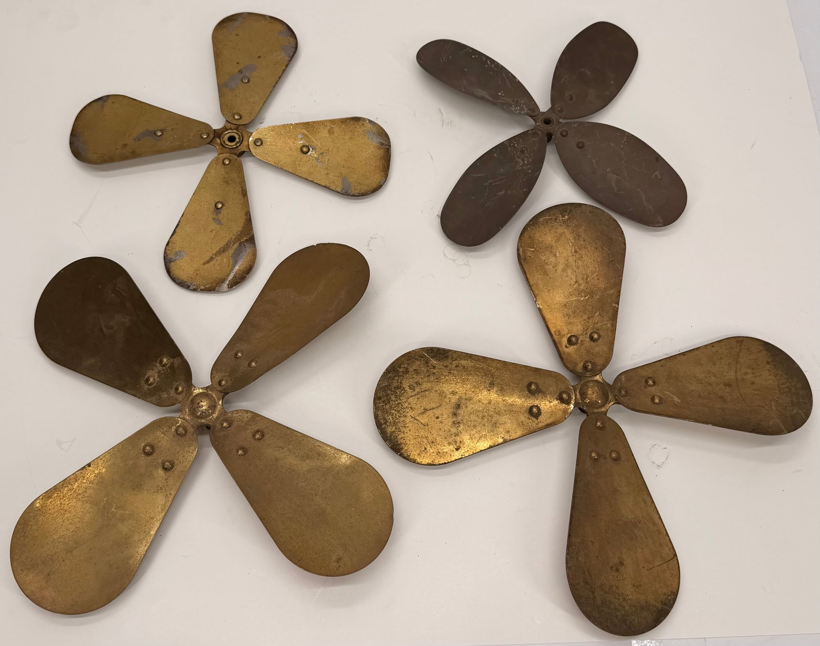 Lot of 4 Antique Brass Fan Blade Assemblies: This lot includes four antique fan blade assemblies from early electric fans. Featuring classic multi-blade construction and attractive aged patina, these original fan components are ideal for restora