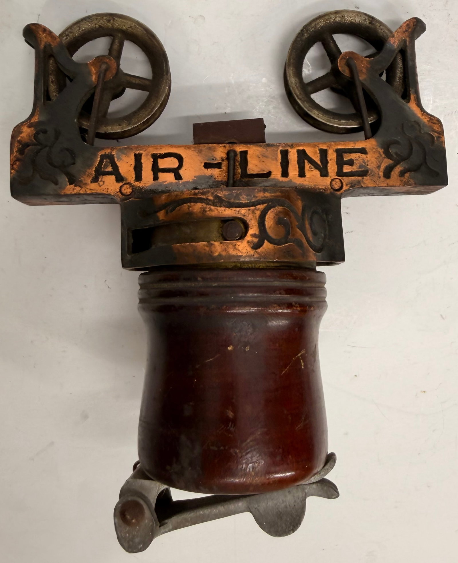 Antique Air-Line Cash Carrier Trolley: This antique Air-Line cash carrier trolley is an original component from the overhead cash transport systems used in department stores during the early 20th century. It features a wooden carrier cup, 