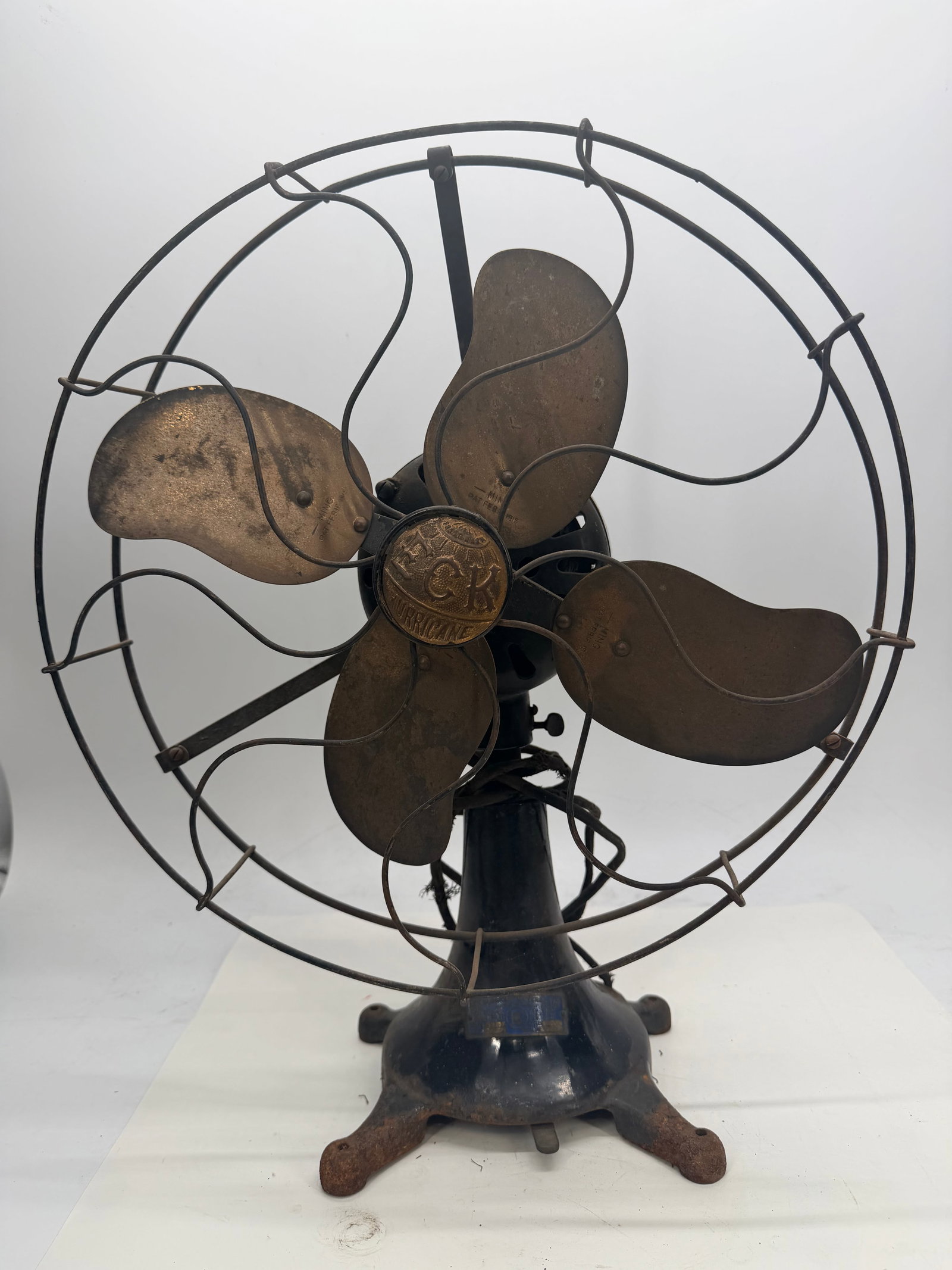 ECK Hurricane Universal Fan: This antique desk/table fan was made by the ECK Dynamo & Motor Co. of New Jersey, USA, and features the “ECK Hurricane” name cast right into the brass hub badge. The four-blade brass propeller