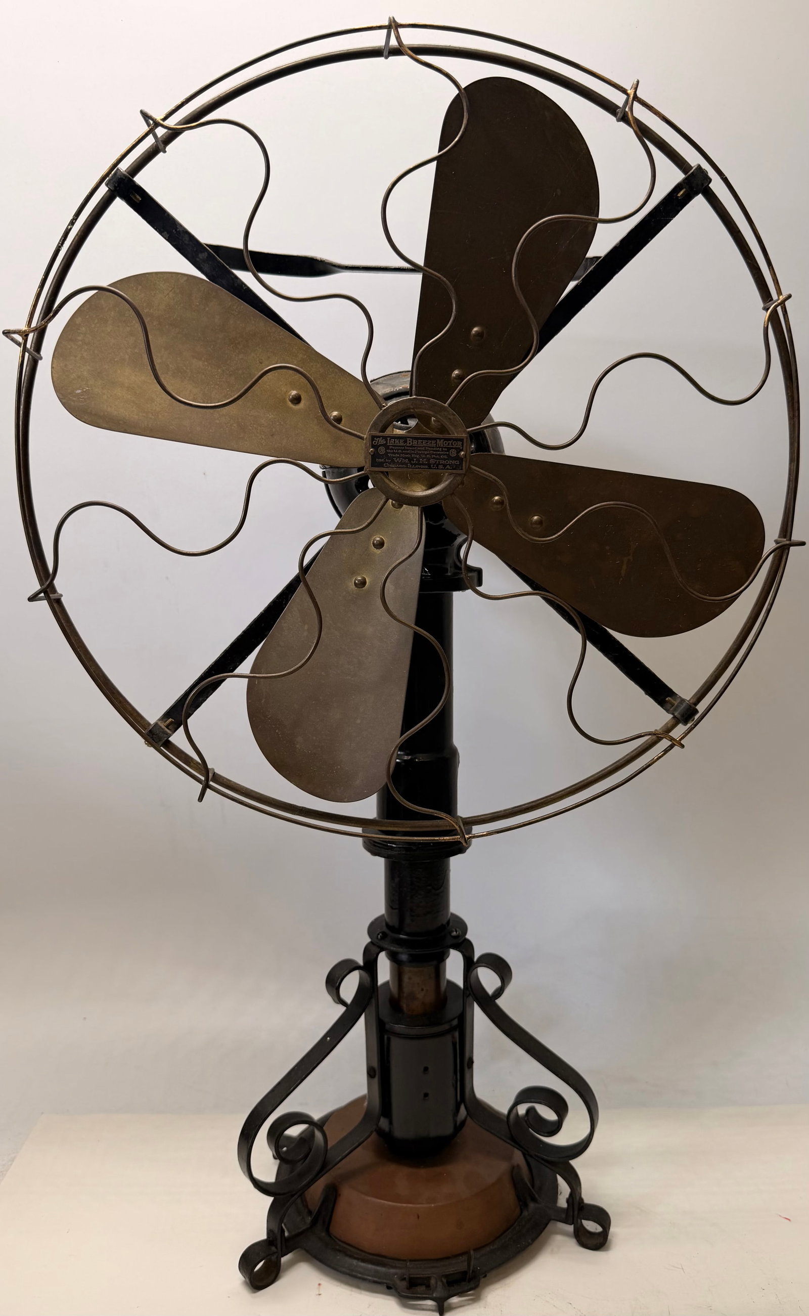 Lake Breeze Stirling Motor Table Fan: This rare Lake Breeze table fan is an early 20th-century example of a heat-powered Stirling motor fan. Rather than using electricity, it operates from heat applied to a copper fluid reservoir in the b