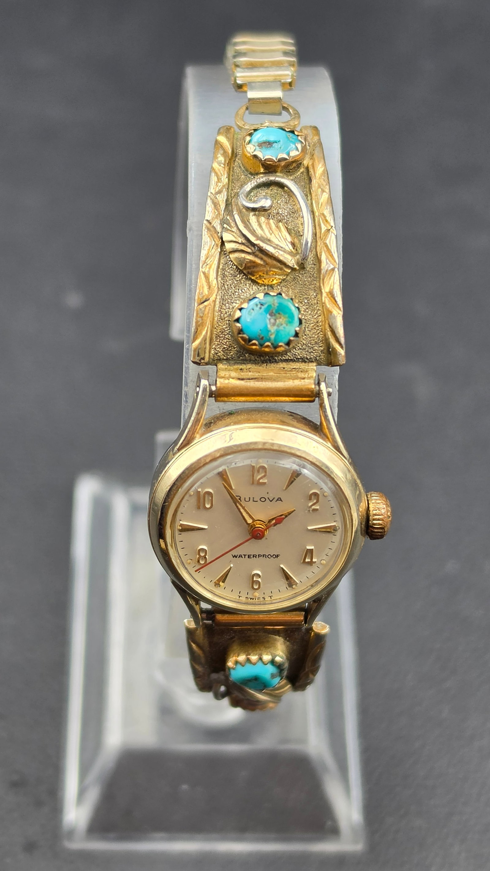 Navajo Wilbur Musket Sterling & Gold-Filled Turquoise Cuff with Bulova M7 Wristwatch, 1967: This Southwestern silver cuff is signed "W.M." on the underside, attributed to Navajo silversmith Wilbur Musket, and stamped "1/20 12K G.F." indicating gold-filled overlay on a sterling silver base. T