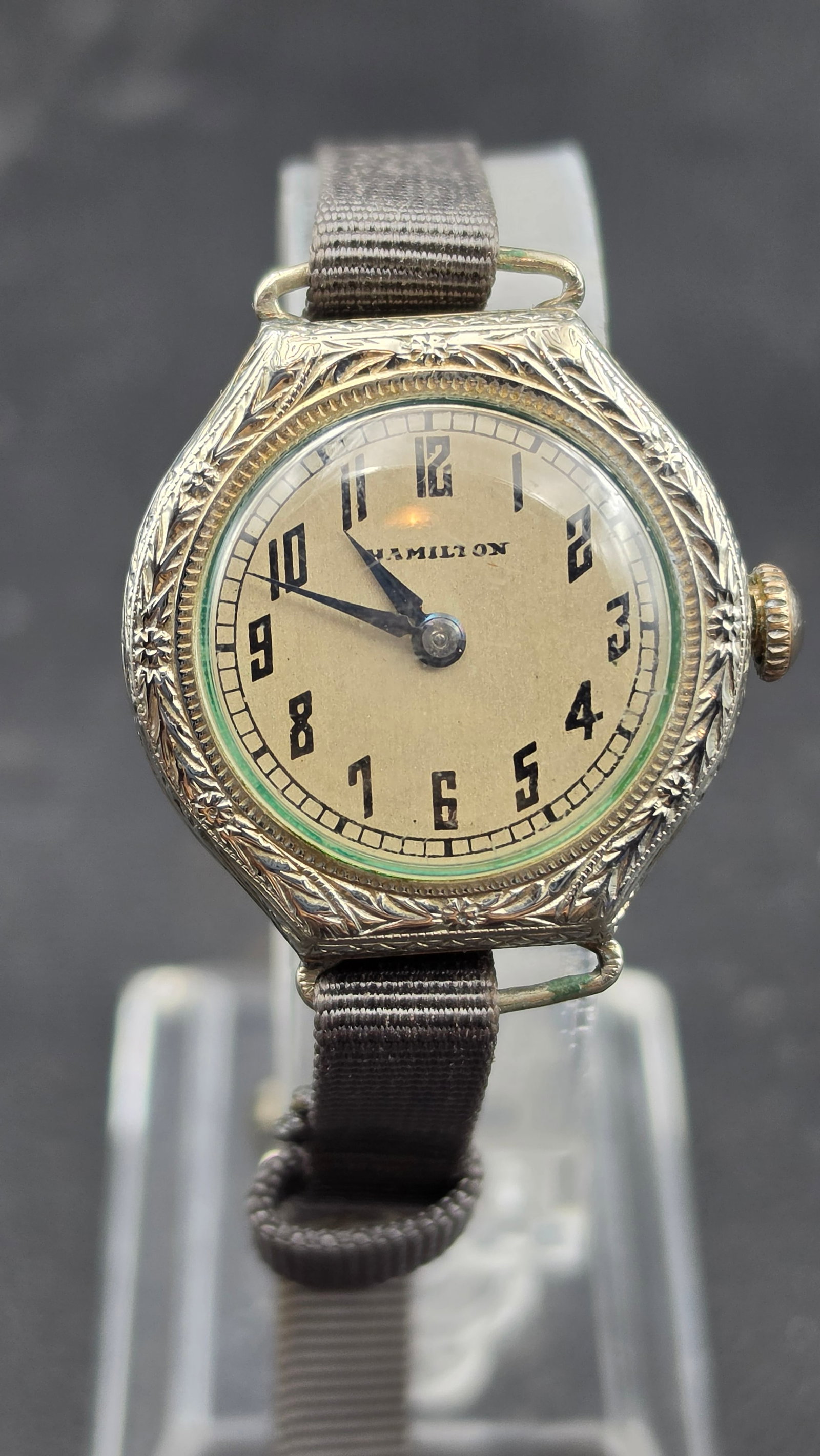 Antique Hamilton Ladies Wristwatch, Engraved Case, 14K White Gold Filled, Circa 1920s, Running: This is an antique Hamilton ladies wristwatch with a round dial signed "Hamilton" in black Arabic numerals with blued steel hands. The case is heavily hand engraved with a floral and foliate motif, ty