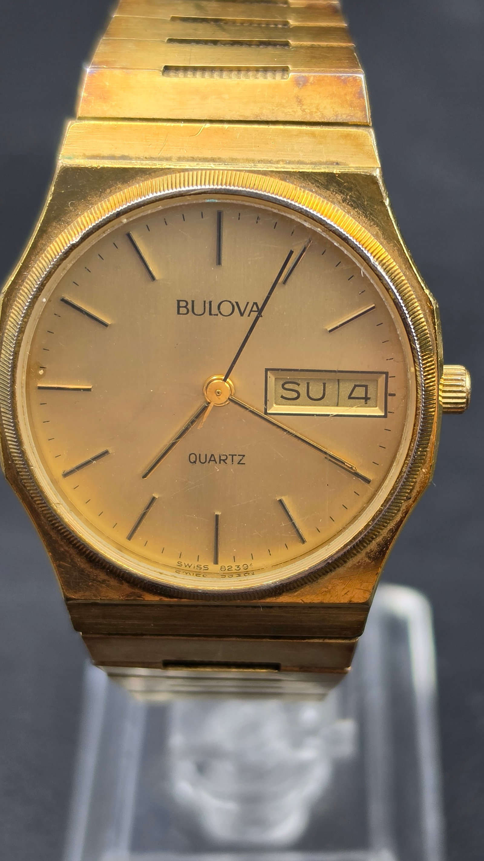 1983 Bulova Quartz Day Date Watch, Ref 132-3E, Swiss 8239, Gold Tone, Steel Back: This is a men's Bulova Quartz dress watch in a gold tone case, measuring approximately 32mm across (measured with digital calipers). The dial is signed Bulova at the top and Quartz below the center, w