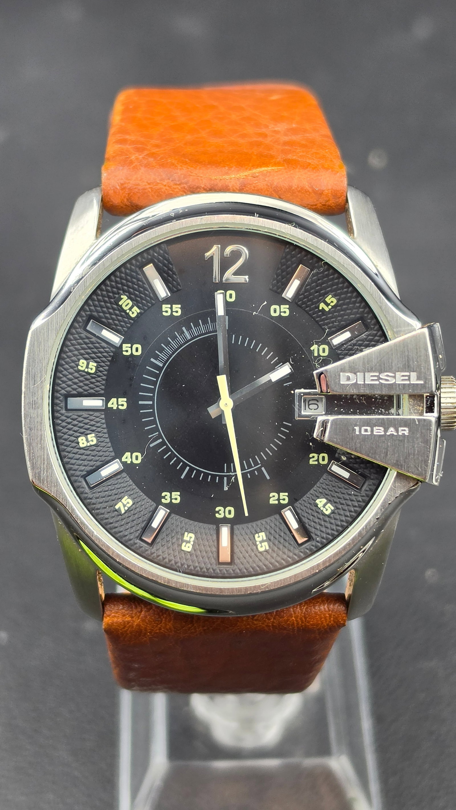 Diesel Master Chief DZ1617 Quartz Watch, Black Dial, Brown Leather Strap, 45mm, 2010s: This is a men's Diesel Master Chief watch in a stainless steel case, measuring approximately 45mm (measured with digital calipers). The black textured dial features an oversized applied 12 numeral, ap