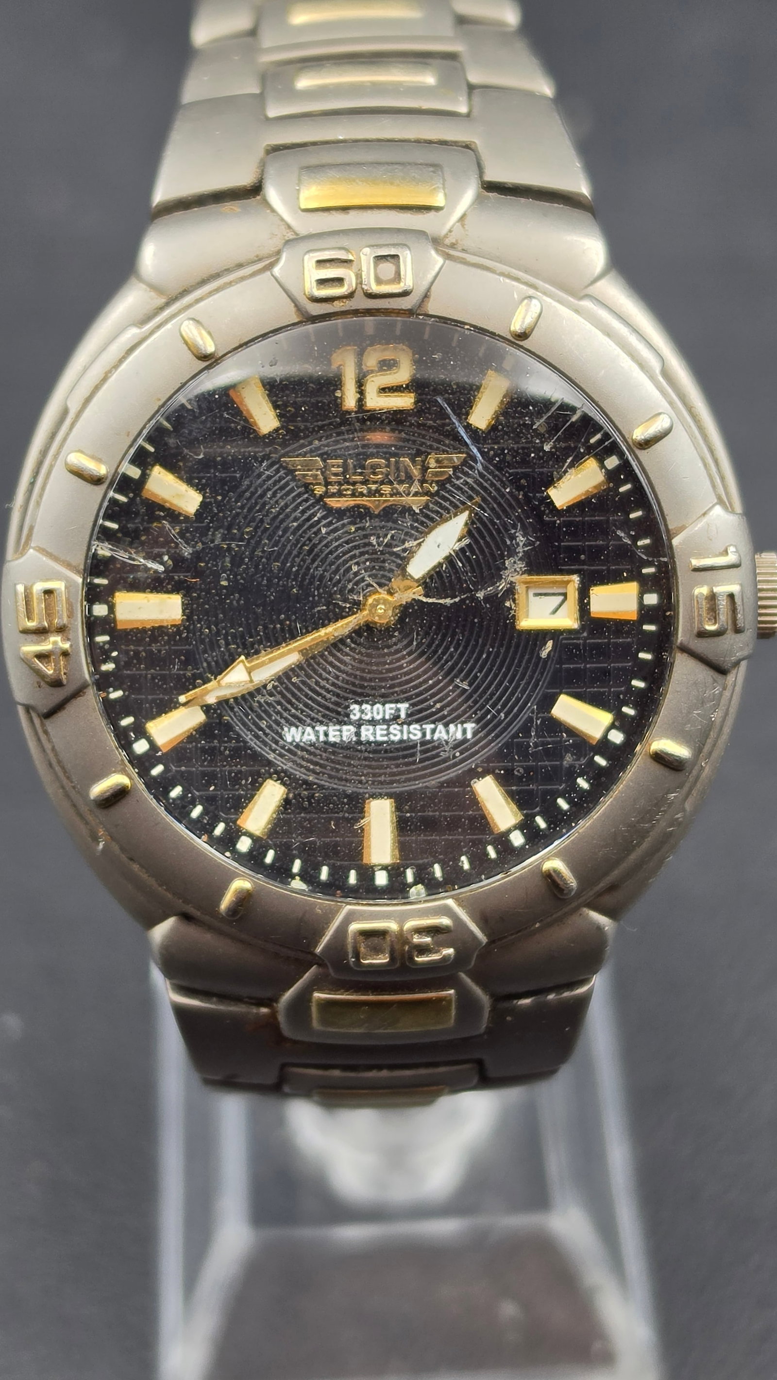 Elgin Sportsman All Titanium Dive Style Watch, Ref FG125, Black Dial, Date, Titanium Bracelet: This is a men's Elgin Sportsman sport watch in an all titanium case, measuring approximately 42.5mm (measured with digital calipers). The black textured dial is signed Elgin Sportsman, with a gold ton