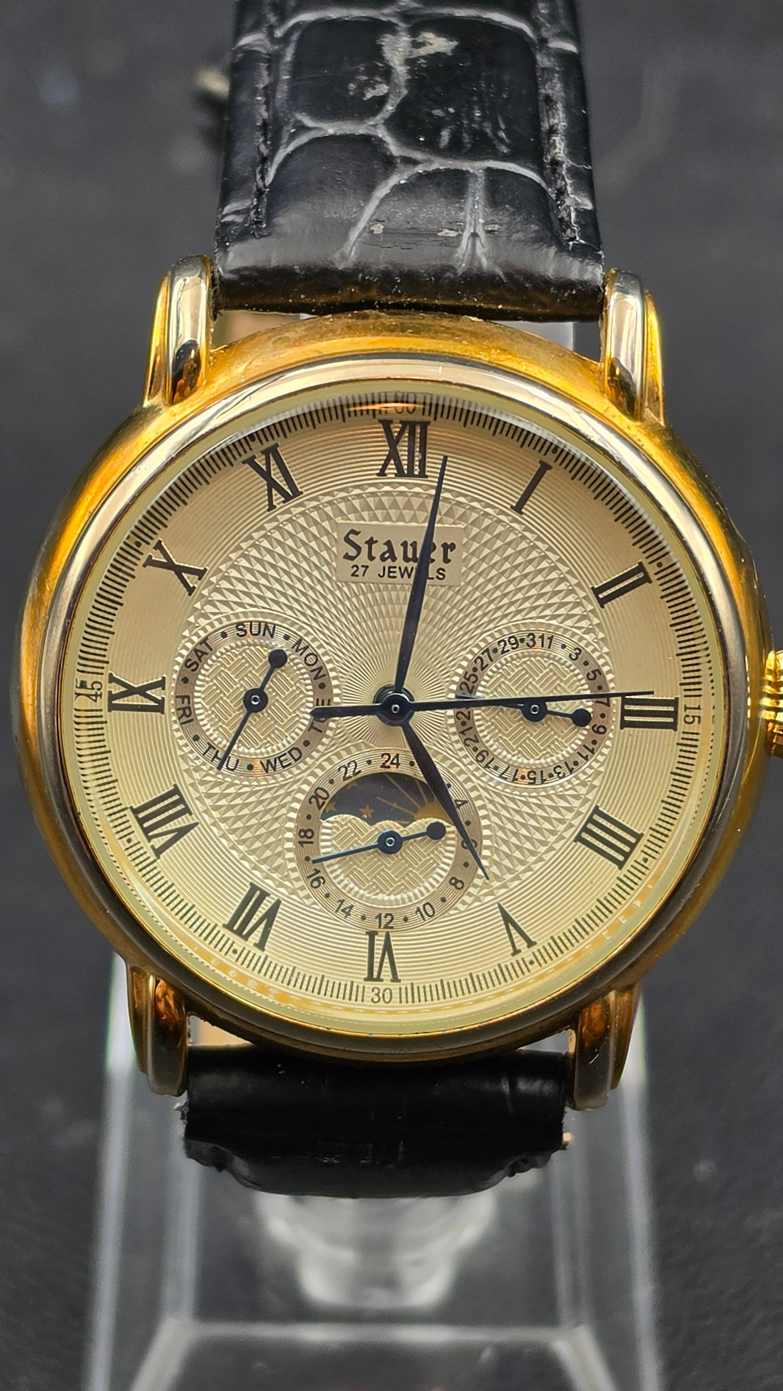 Stauer Magnificat 27 Jewels Automatic Moon Phase Watch Ref 20193: Stauer Magnificat automatic wristwatch, case width measuring 39.90mm, in a gold tone case with an exhibition case back revealing the 27 jewel China made automatic movement, marked Stauer, 3ATM Water R