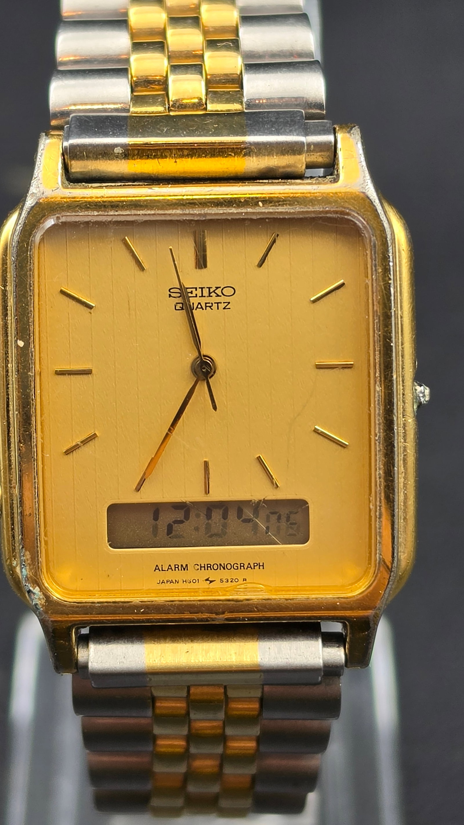 Vintage Seiko H601-5349 Duo-Display Ana-Digi Alarm Chronograph Watch Two Tone 1980s: This is a Seiko Duo-Display quartz Alarm Chronograph, reference H601-5349, part of Seiko's H601/H801 ana-digi family that combines an analog dial with a digital sub-display for calendar, alarm, and st