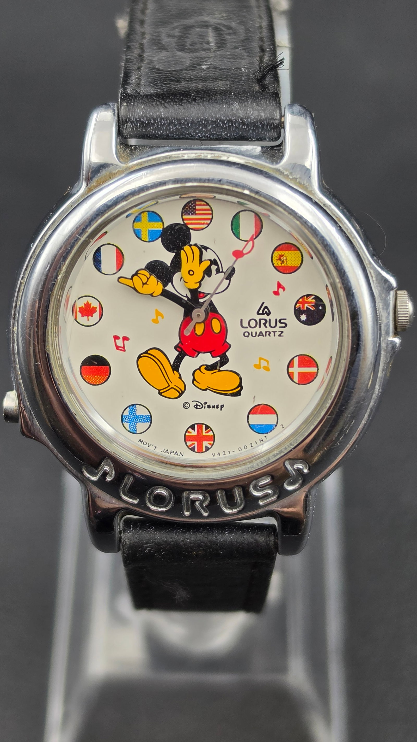 Vintage Lorus Disney Mickey Mouse Musical Watch, "It's a Small World," World Flags Dial, New Battery: This is a vintage Lorus Quartz Disney watch, model V421-0020, featuring Mickey Mouse with animated pointer hands on the dial. Case diameter measures approximately 34mm as verified with digital caliper