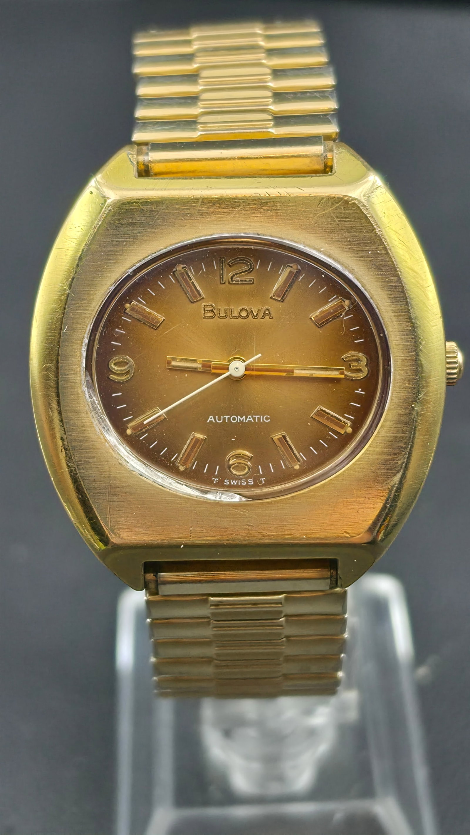Vintage 1973 Bulova Automatic Watch Gold Tone 17 Jewels Caliber 11ANAC 37mm: This is a vintage 1973 Bulova automatic wristwatch, dated by the case back code N3, powered by a Bulova caliber 11ANAC movement with 17 jewels, marked UNADJUSTED and SWISS on the movement bridge. The 
