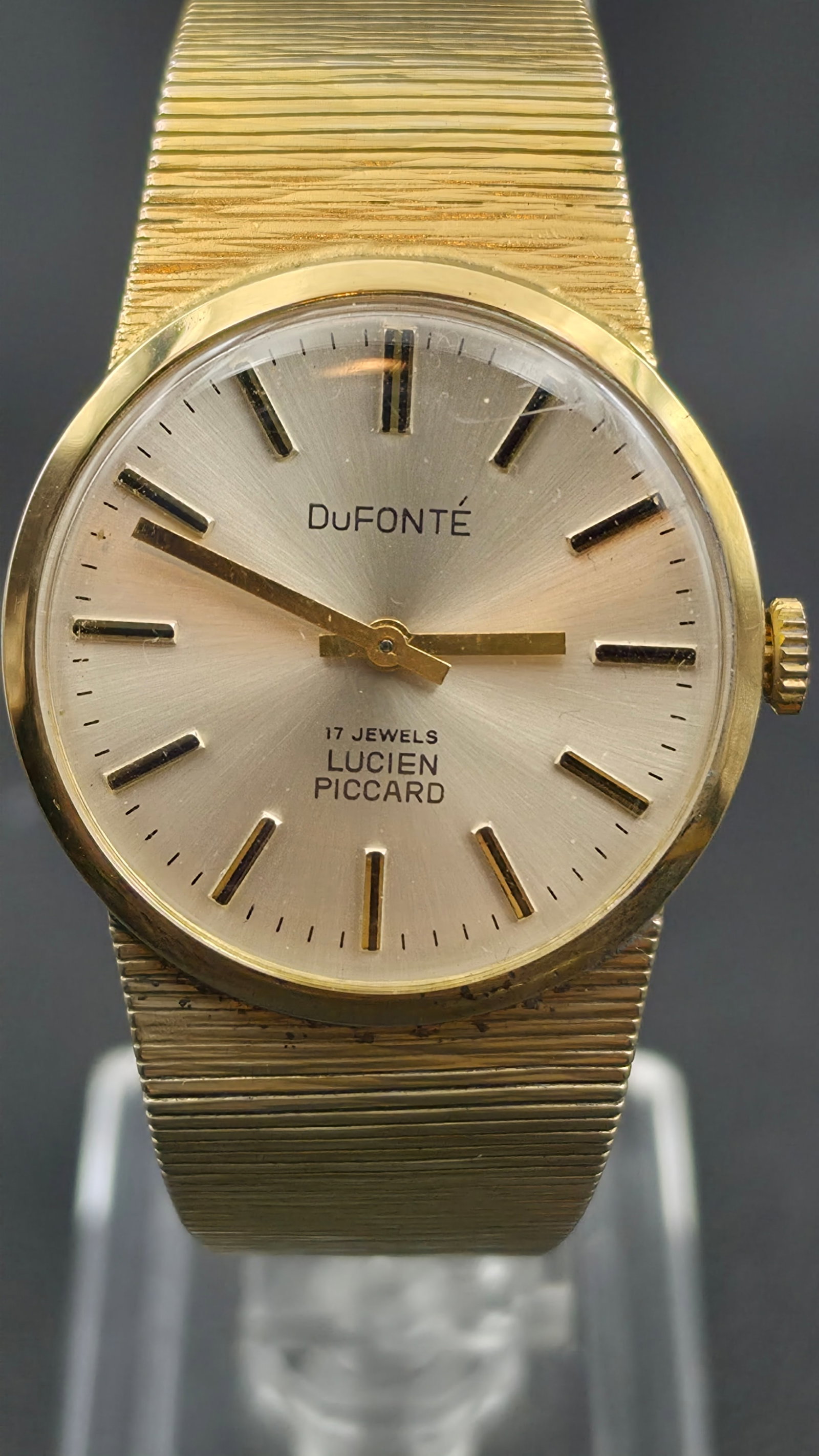 Vintage Dufonte by Lucien Piccard 17 Jewel Gold Tone Mesh Bracelet Mens Watch: Vintage DuFONTE by Lucien Piccard manual wind wristwatch with a round gold tone case measuring approximately 32.28mm in diameter. Silver sunburst dial signed DuFONTE with applied gold tone baton indic