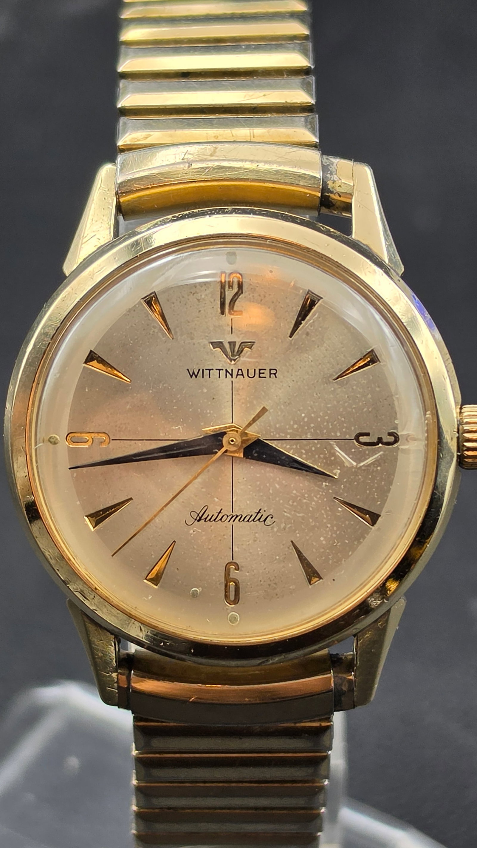 Vintage Longines-Wittnauer 11SN 17 Jewel Automatic Watch 10K GF Bezel Running: This is a vintage Wittnauer automatic wristwatch with a champagne dial, applied gold-tone dagger markers, Arabic numerals at 12, 3, 6, and 9, and blued steel hands, signed Wittnauer and Automatic belo