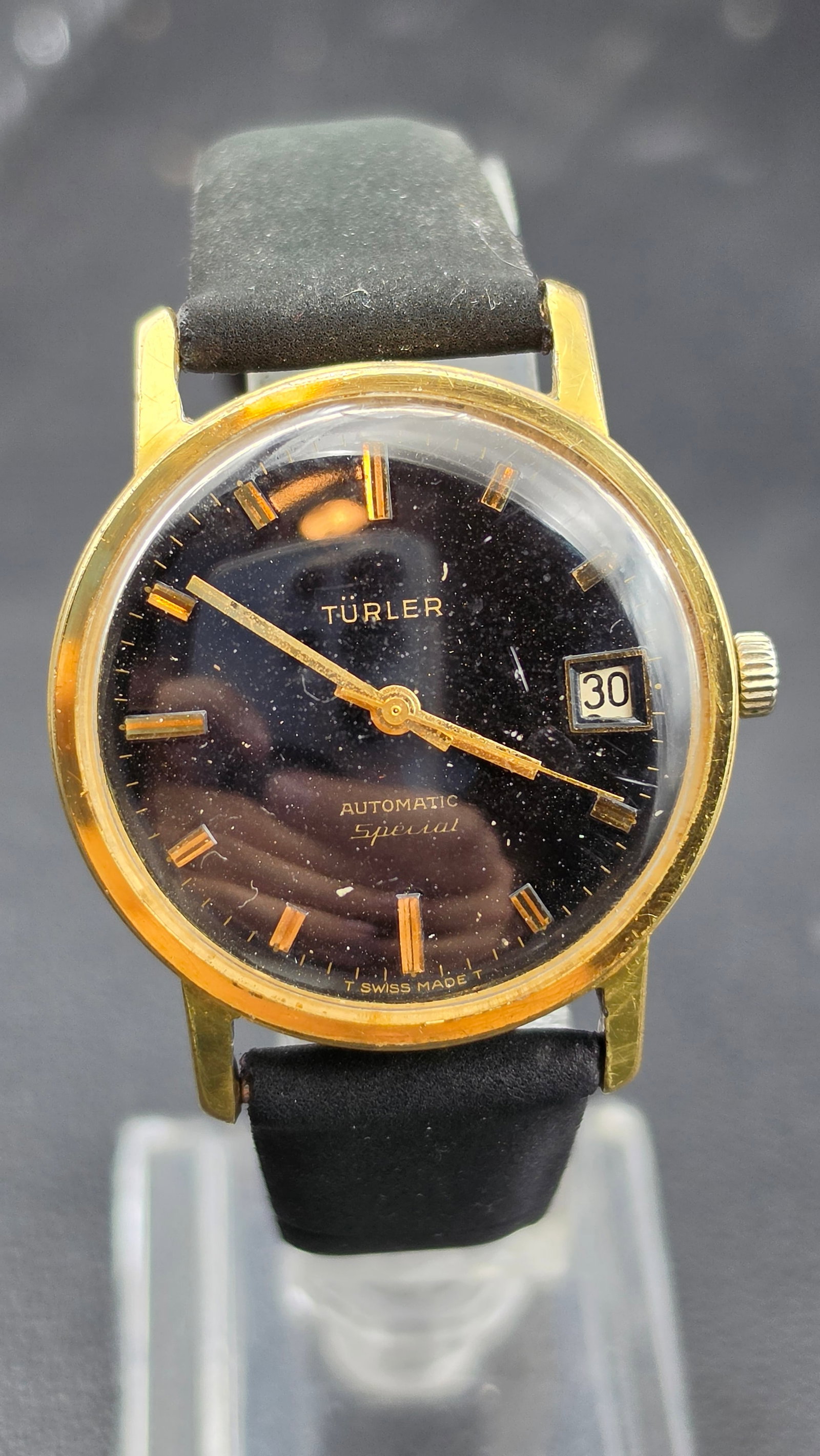 Vintage Türler Automatic Special Black Dial Date Watch Running: This is a vintage Türler Automatic Special wristwatch with a black dial, gilt baton hour markers, a date window at 3 o'clock, and signed Türler, Automatic, Special, T Swiss Made T. The case measures