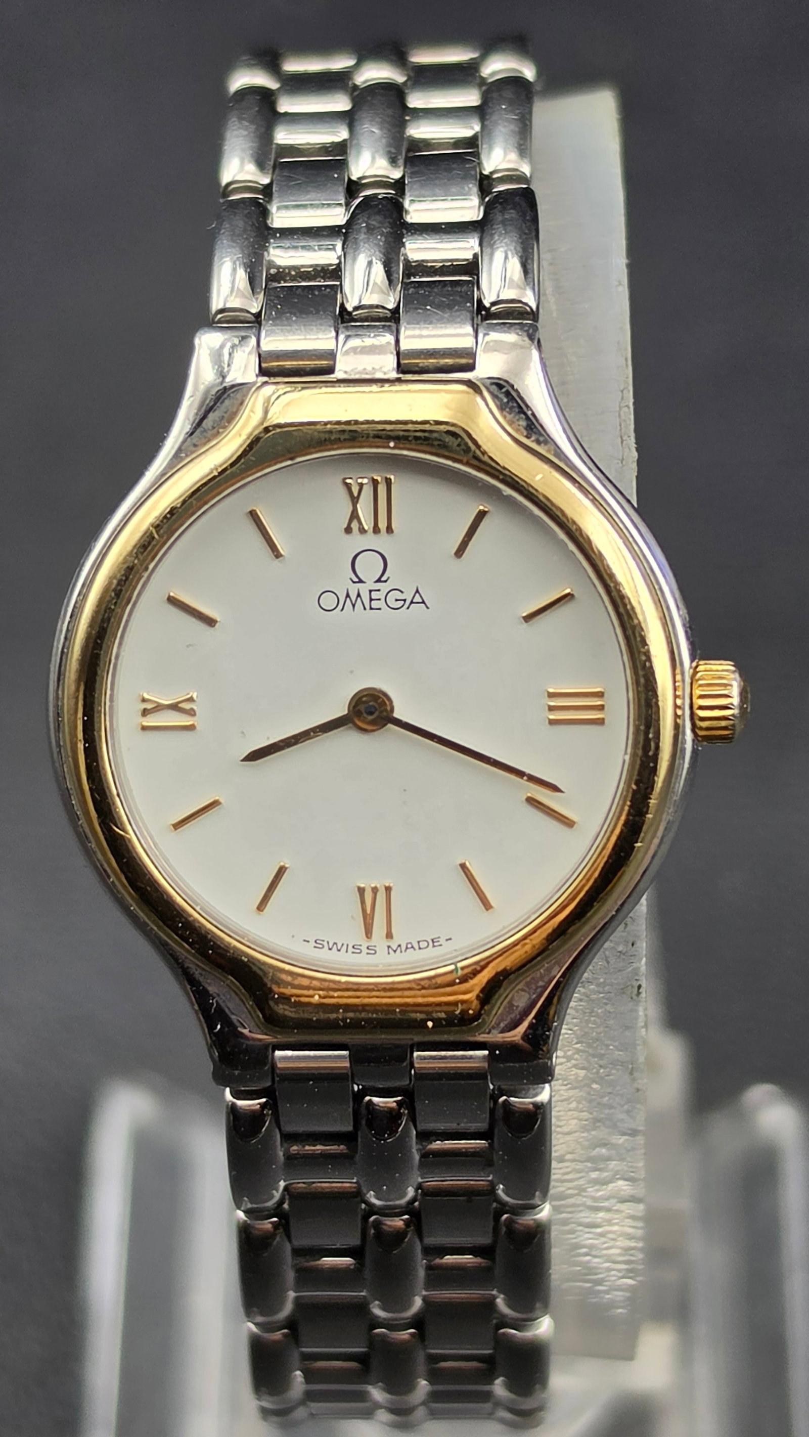 Omega De Ville Ladies Two-Tone Quartz Watch Ref. 6101/433 New Battery: This is an Omega De Ville ladies quartz wristwatch, reference 6101/433, with a white dial featuring gold-tone Roman numerals at 12, 3, 6, and 9, applied baton markers, and gold-tone dagger hands, sign
