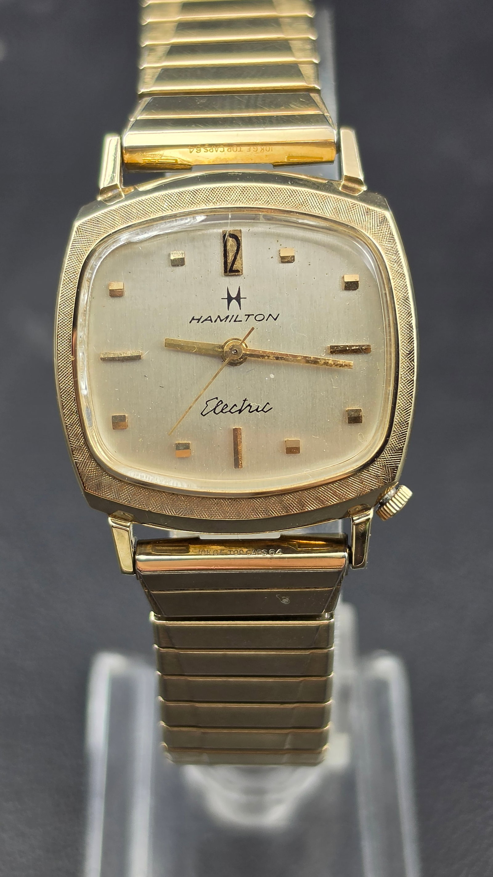 Hamilton Electric 10K RGP Cal 505 Cushion Case Watch 29mm 1960s Running: This is a Hamilton Electric wristwatch with a cushion shaped case measuring 29mm in width and a textured bezel. The dial reads Hamilton with the winged H logo, and Electric in script below, with appli