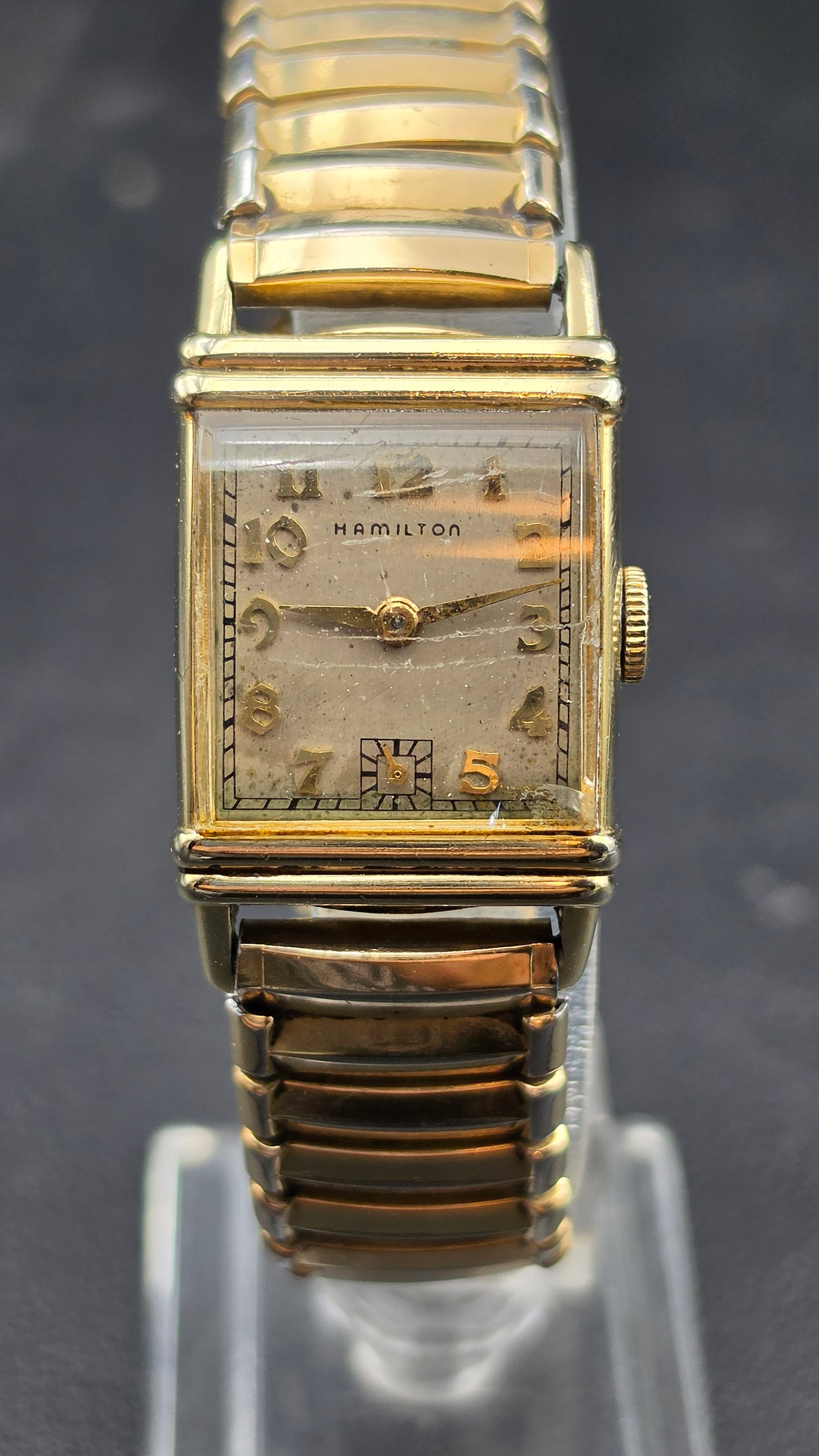 Hamilton 14K Gold Filled Cal 982 19 Jewel Rectangular Watch 1940s Running: This is a Hamilton rectangular wristwatch in a 14K gold filled case. The dial is signed Hamilton with Arabic numerals, a sub-seconds register at 6, and gold tone hands. The case back is stamped Hamilt