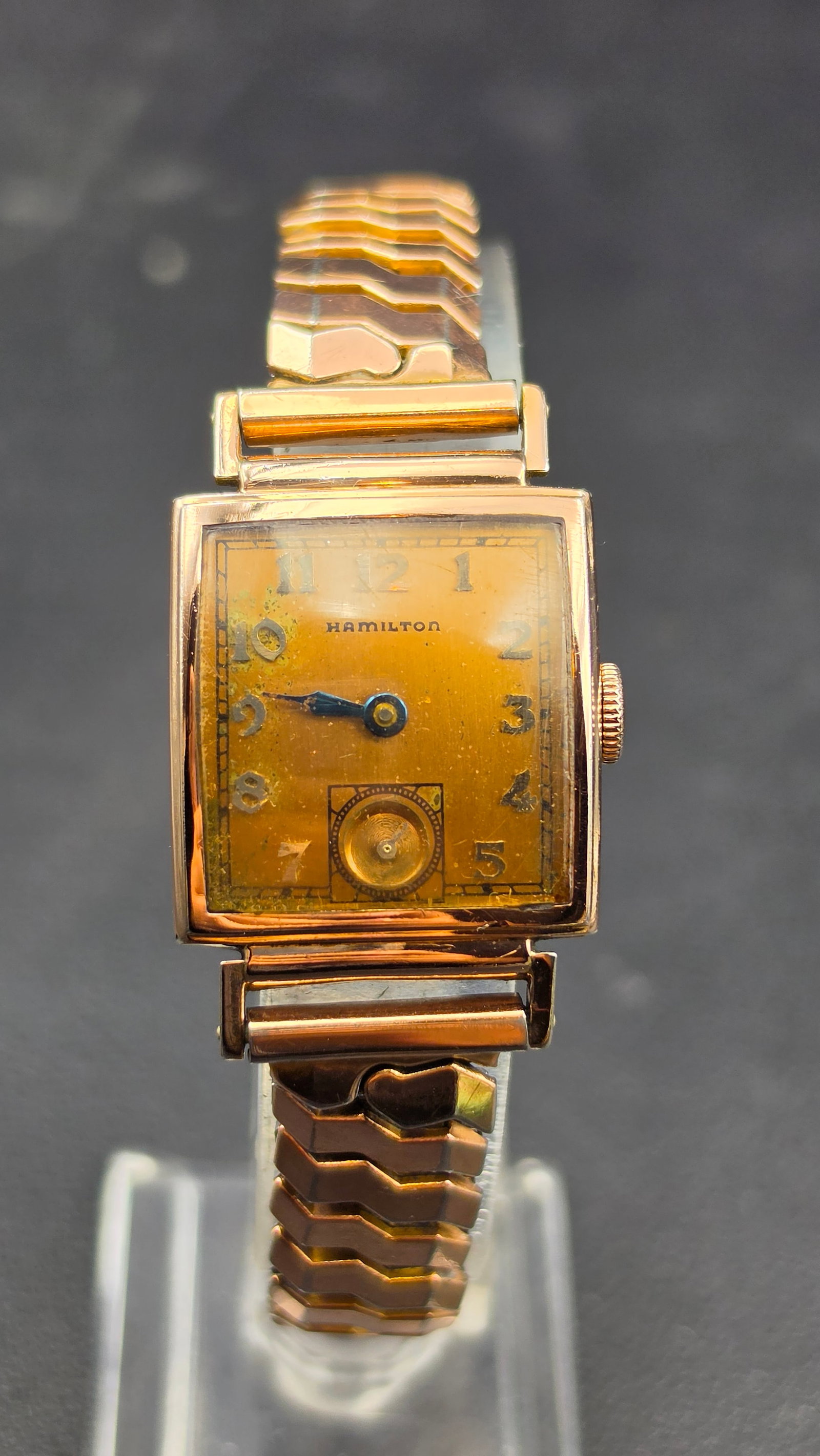Hamilton 14K Rose Gold Filled Cal 982 19 Jewel Rectangular Watch 24mm 1930s Running: This is a Hamilton rectangular wristwatch in a 14K rose gold filled case measuring 24mm in width, with a case side stamped W, 14K Gold Filled. The dial is signed Hamilton with Arabic numerals, a sub-s