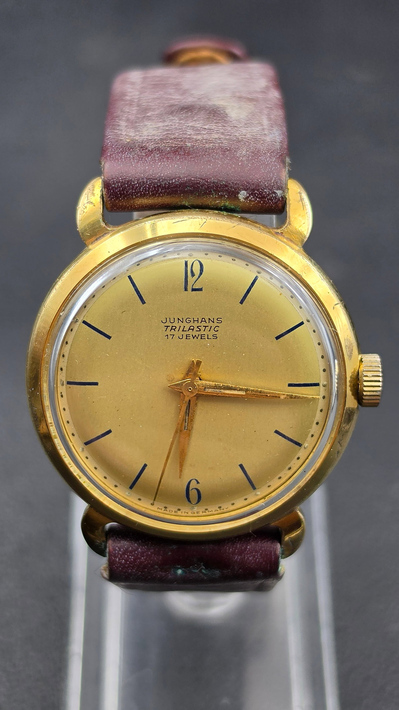 Vintage Junghans Trilastic 17 Jewel Cal. 98/1 Manual Wind Men's Watch - Made in Germany, 1950s: This vintage Junghans Trilastic wristwatch features a gold dial signed "Junghans Trilastic 17 Jewels" and "Made in Germany," with blue baton markers, Arabic 12 and 6, and blued dauphine-style hands. T