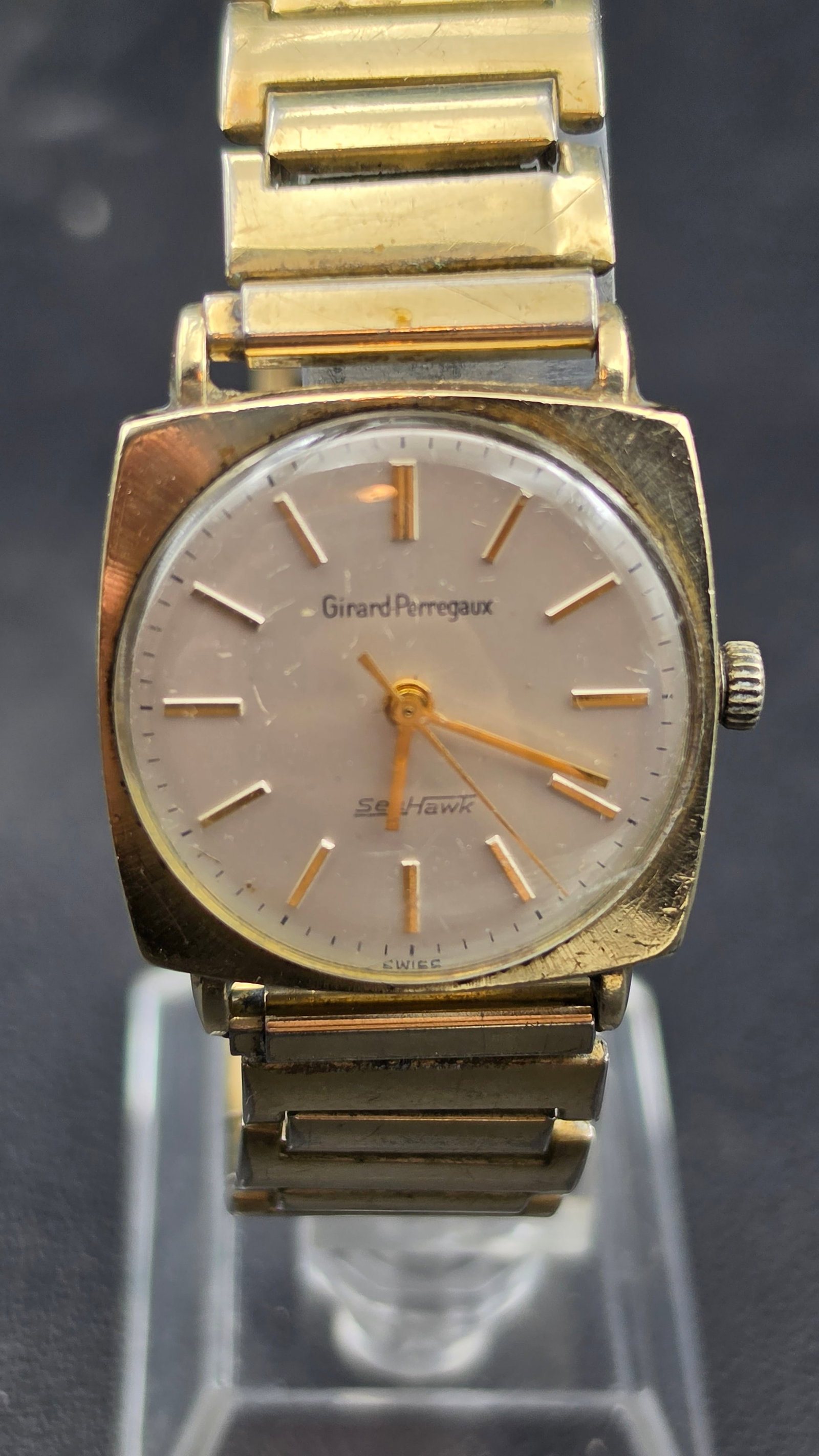 Vintage Girard-Perregaux Sea Hawk 10K Gold Filled Men's Watch, Swiss: This vintage Girard-Perregaux wristwatch features a cushion-shaped case with a cream dial signed "Girard-Perregaux" and "Sea Hawk," with applied gold-tone baton markers and dauphine hands. The case ba