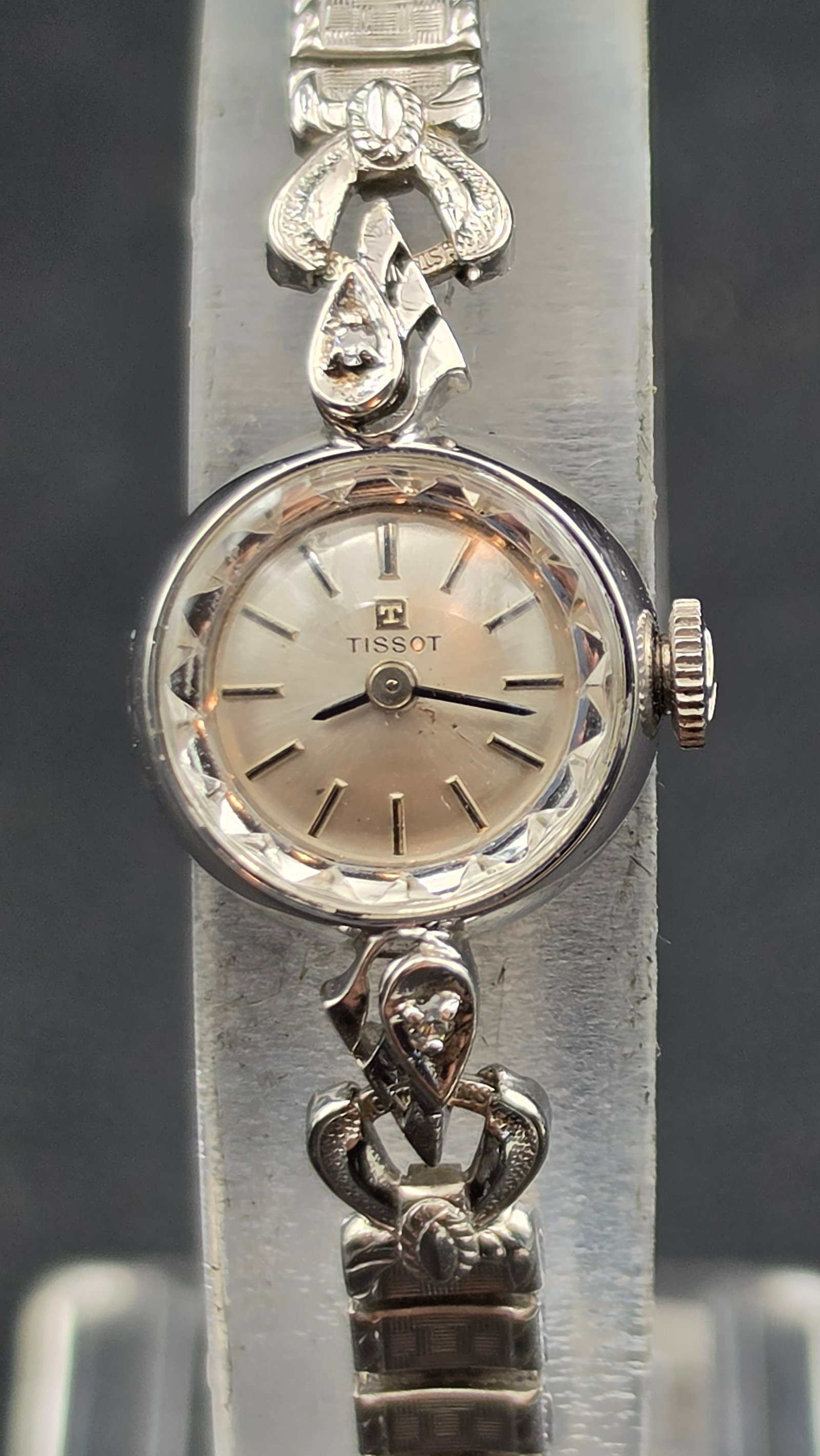 Vintage Tissot Ladies Cocktail Watch, Ref. TE2406, Diamond-Set Bracelet Links: This vintage Tissot ladies wristwatch features a silver dial signed "Tissot" with a faceted crystal bezel, applied baton markers, and dauphine hands. The case back is stamped "Stainless Steel, 10K RGP