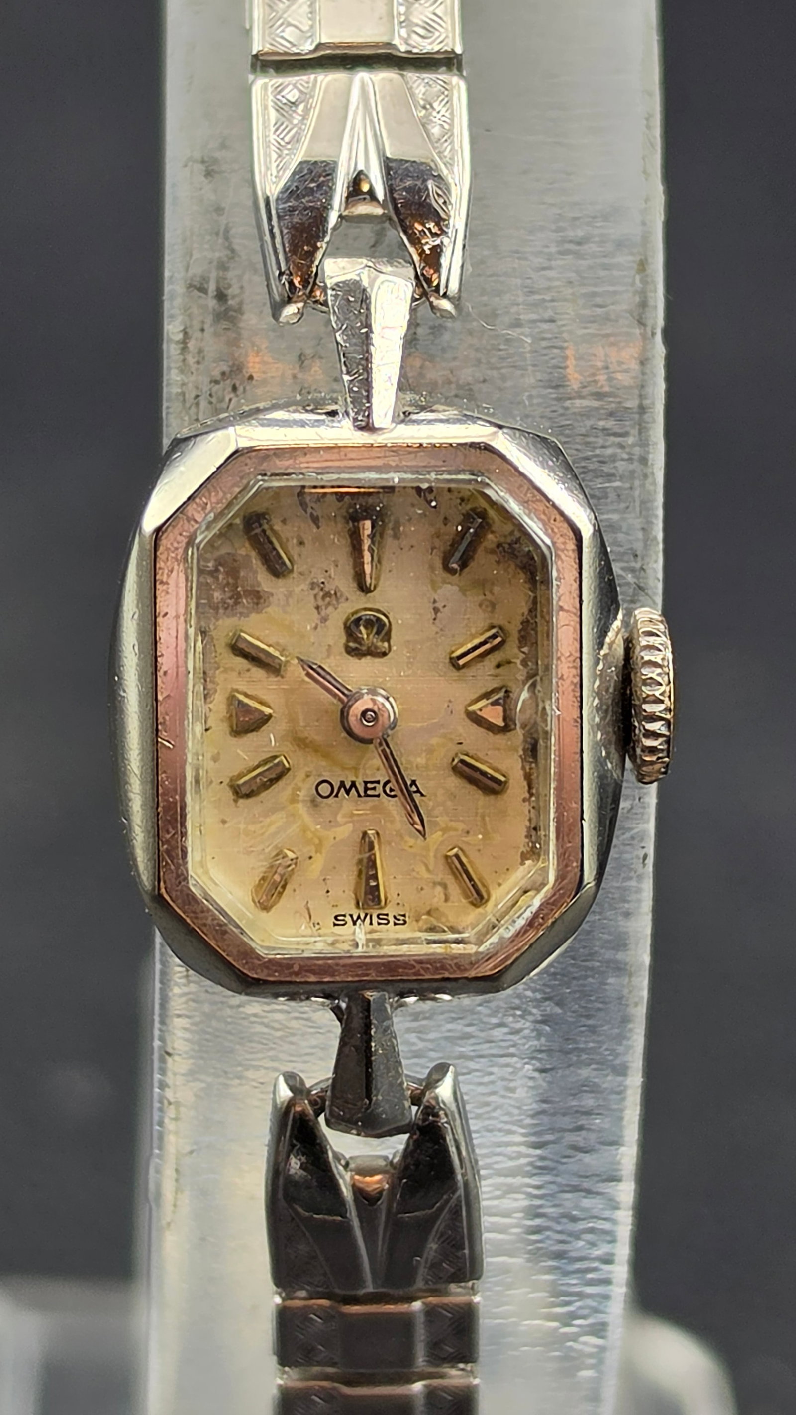 Vintage Omega Ladies Cocktail Watch, 14K White Gold Filled, Cal. 484: This vintage Omega ladies wristwatch features an octagonal case with a two-tone bezel and a champagne dial signed "Omega" and "Swiss," with applied gold-tone baton and triangular markers. The case bac
