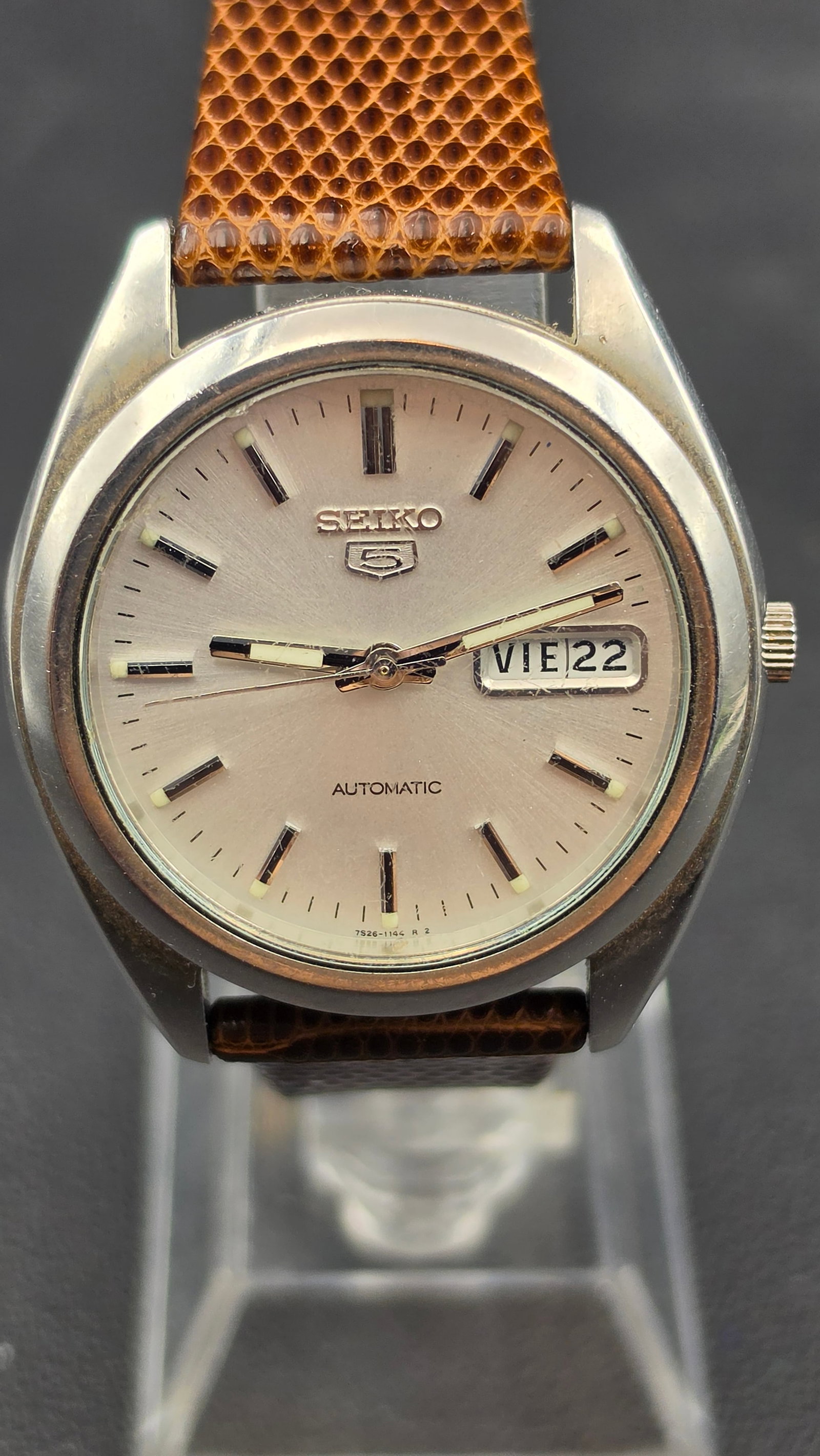 Vintage Seiko 5 Automatic Day Date 21 Jewel Stainless Steel Wristwatch: This is a Seiko 5 automatic wristwatch, signed Seiko 5 on the dial with the Automatic designation below and a day/date window at 3 o'clock. It is powered by the Seiko caliber 7S26, a 21 jewel automati