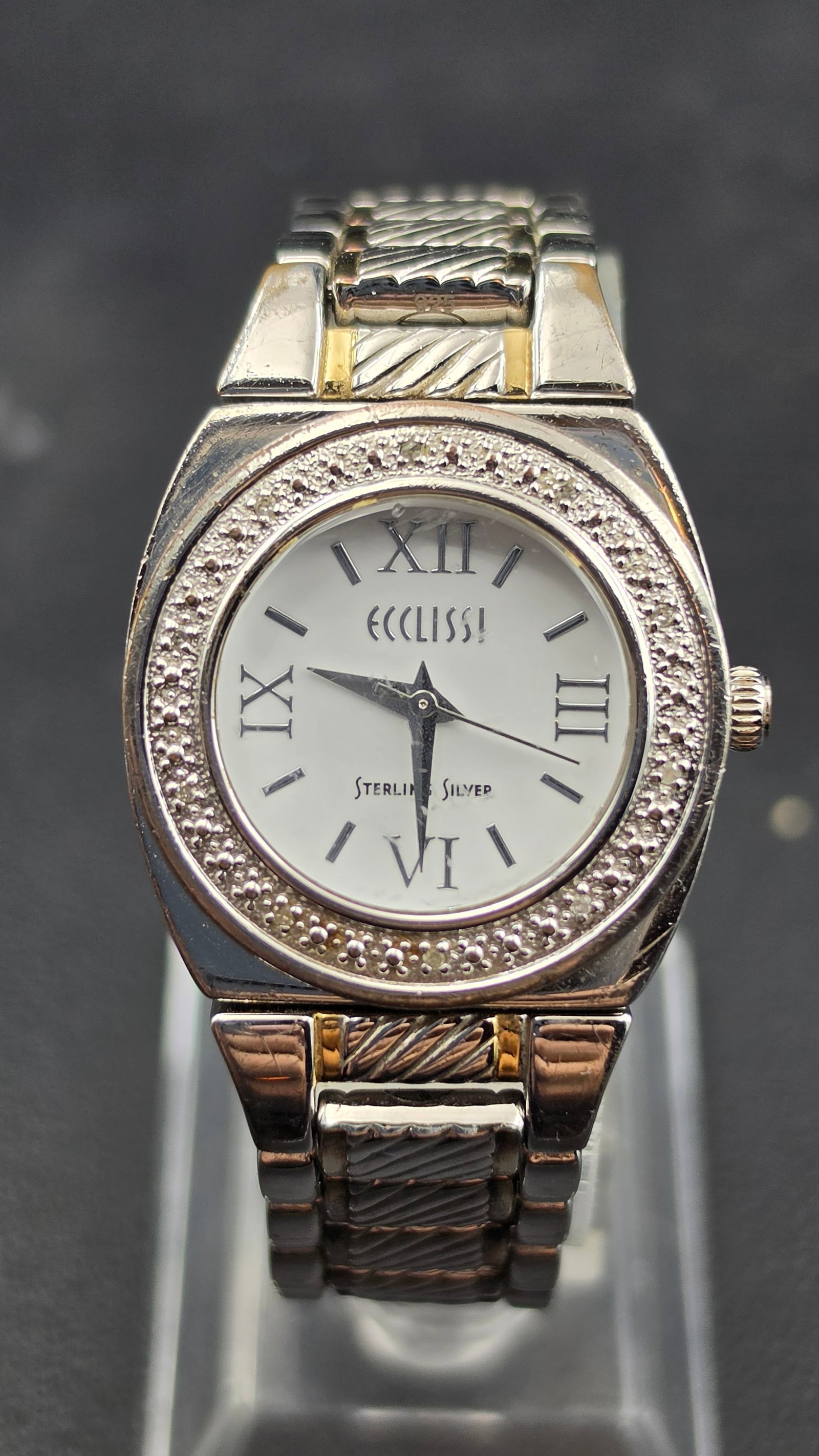 Ecclissi Sterling Silver Watch with Interchangeable Bezels in Original Box: This is an Ecclissi sterling silver watch, signed Ecclissi and Sterling Silver on the mother-of-pearl style dial with Roman numeral markers at 12, 3, 6, and 9. The case back is signed Ecclissi, Sterli