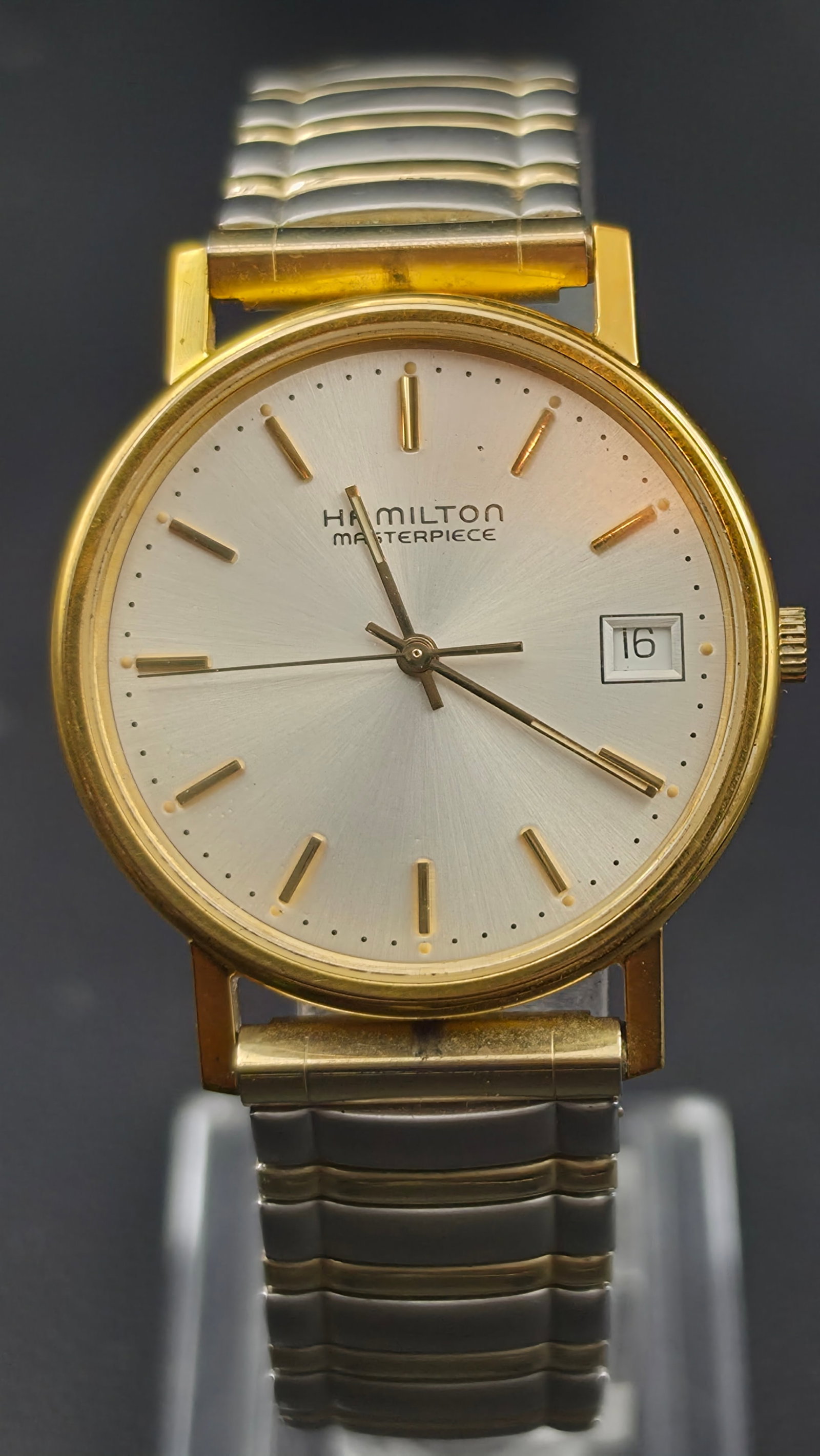 Vintage 1990s Hamilton Masterpiece 10K GF Quartz Wristwatch, Two-Tone, New Battery, Box & Papers: This Hamilton Masterpiece quartz wristwatch features a silvered dial signed Hamilton Masterpiece with applied gold-tone baton markers and a date window at 3 o'clock, in a 10K gold filled case measurin