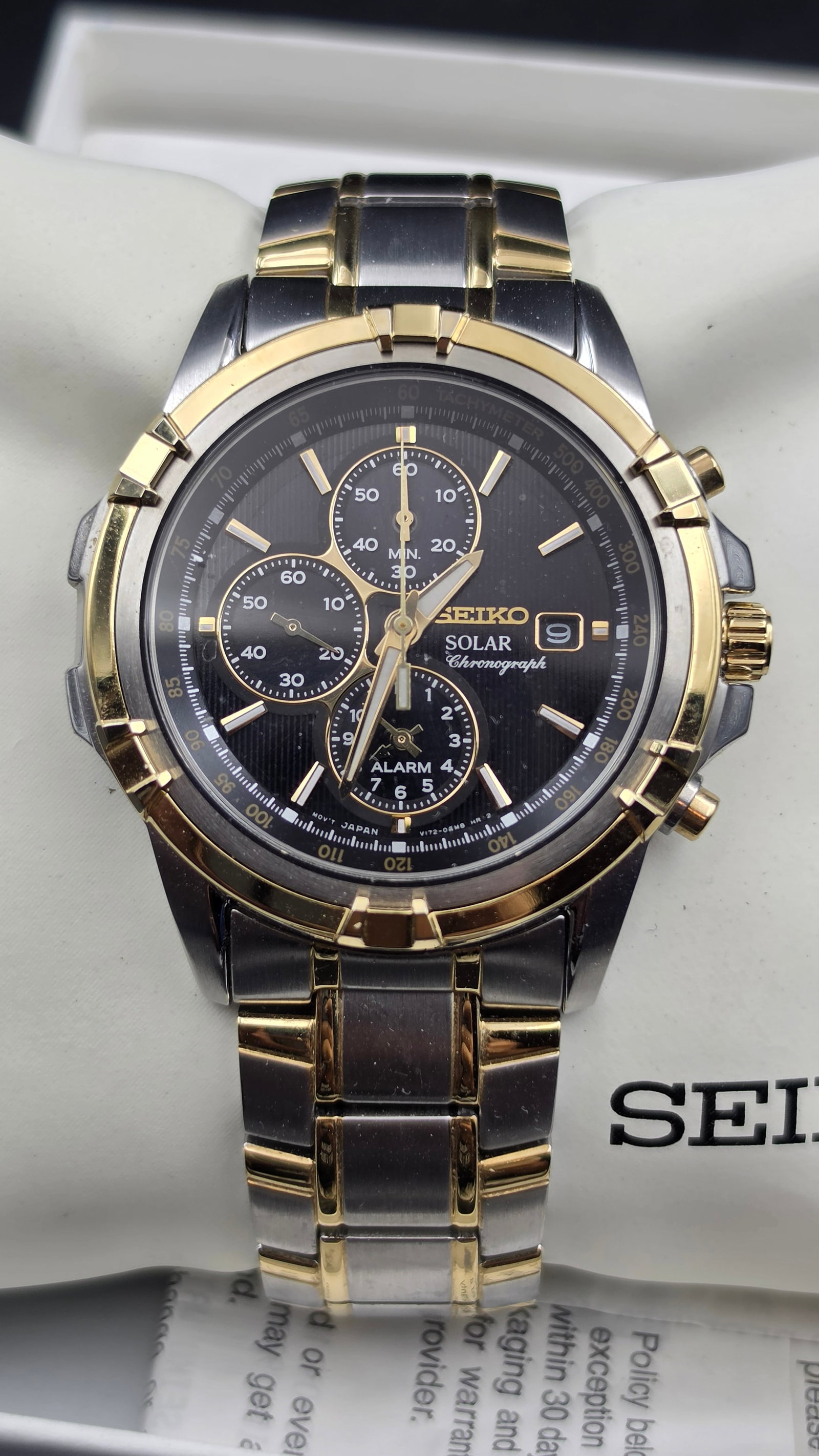 Seiko Solar Chronograph Alarm Watch, Ref V172-0AJ0, Two-Tone, NOS, Box & Papers: This Seiko Solar Chronograph, caliber V172, features a black dial signed Seiko Solar Chronograph with a tachymeter scale, three subdials (60 minute chronograph, running seconds, and 12 hour alarm), a 