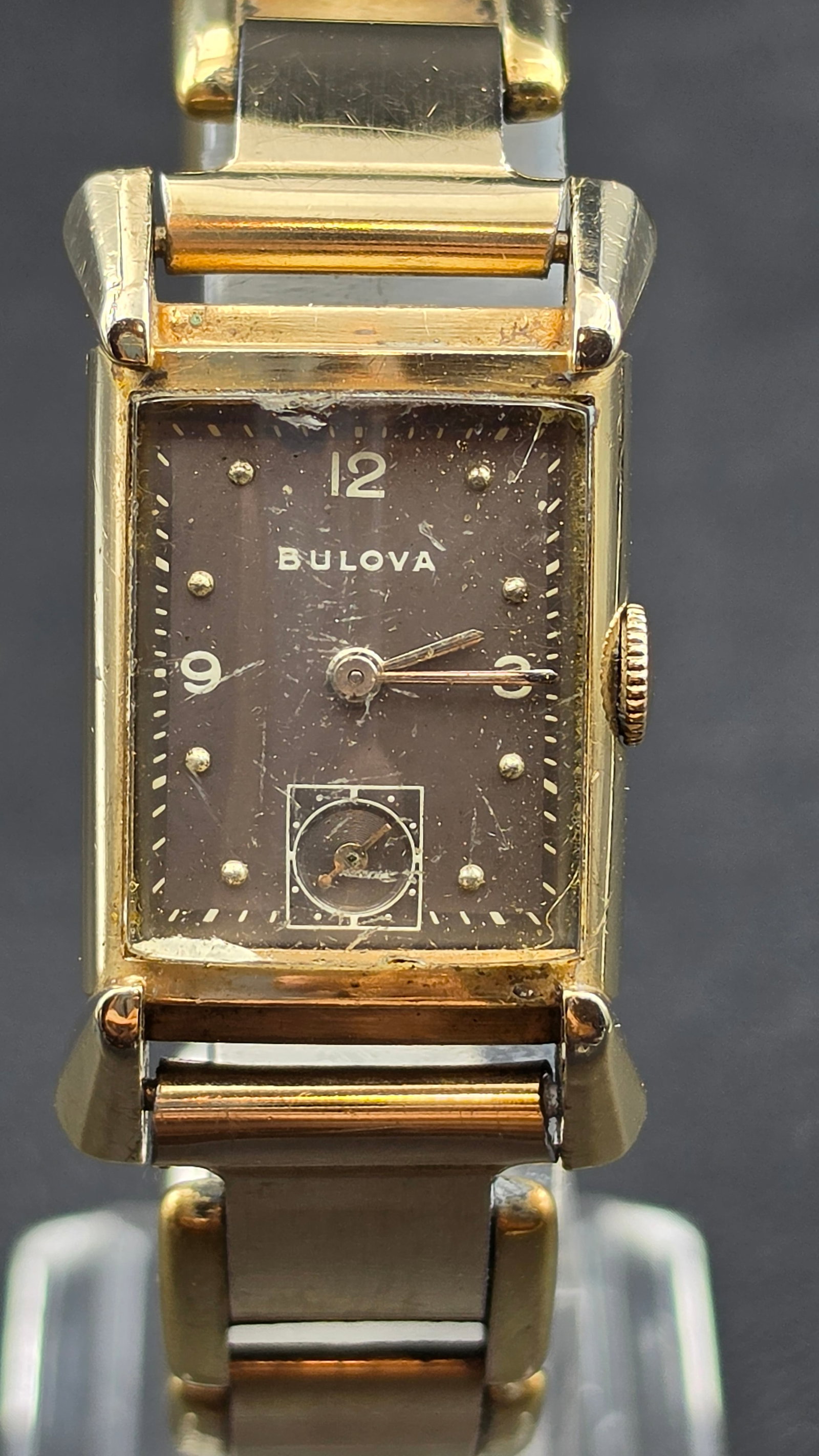 Vintage 1930s-40s Bulova Fifth Avenue New York Tank Watch 21 Jewels 10K Gold Filled Running: This is a vintage Bulova Fifth Avenue New York rectangular tank-style wristwatch in a 10K gold filled case, serial 8285828. The gilt dial is signed Bulova with Arabic numerals at 12, 3, and 9, a subsi