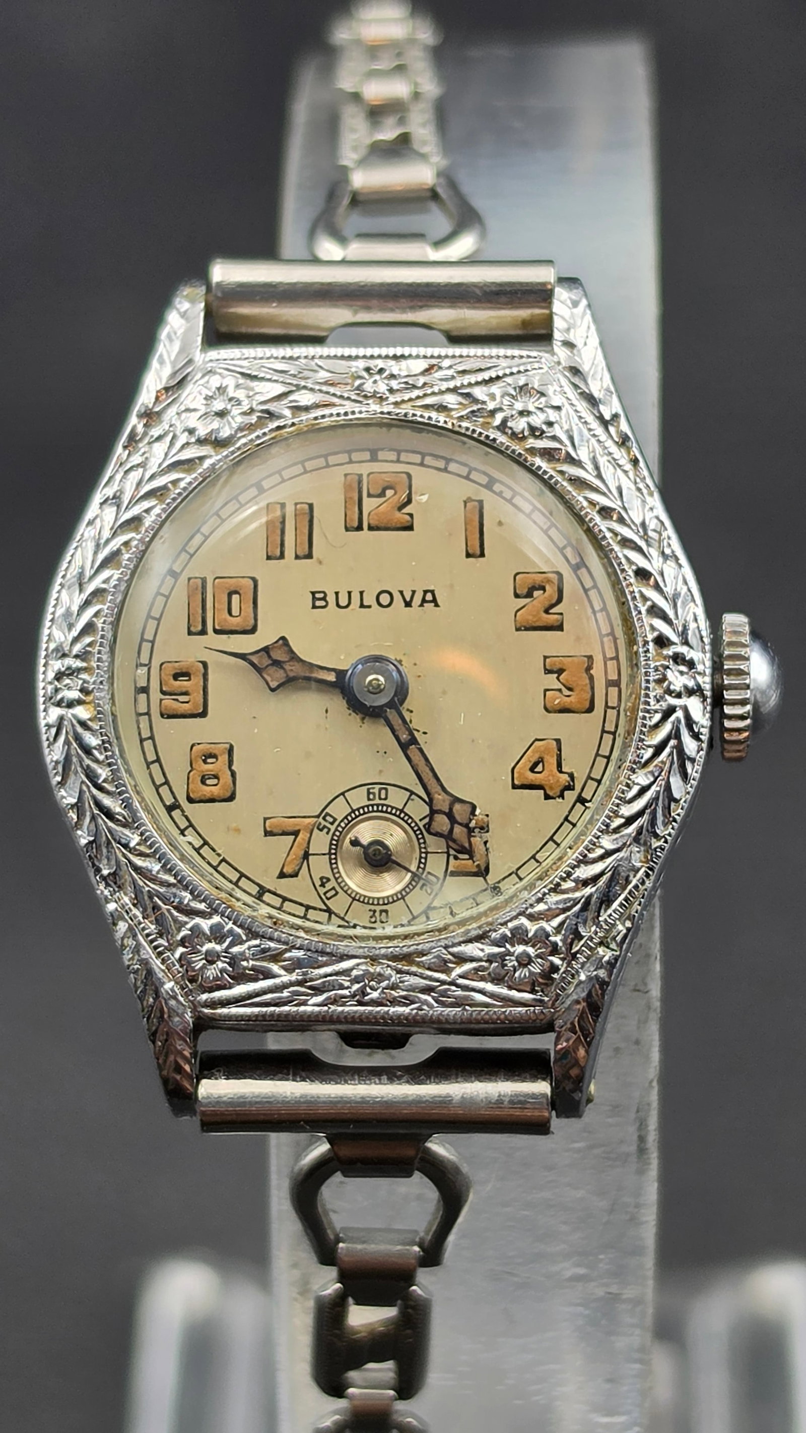 1924 Bulova Art Deco Engraved Ladies Watch 15 Jewels 14K Rolled Gold Plate Running: This is a 1924 Bulova Art Deco ladies wristwatch in an engraved octagonal cushion case with floral and foliate motifs. The cream dial is signed Bulova with Arabic numerals and a subsidiary seconds dia