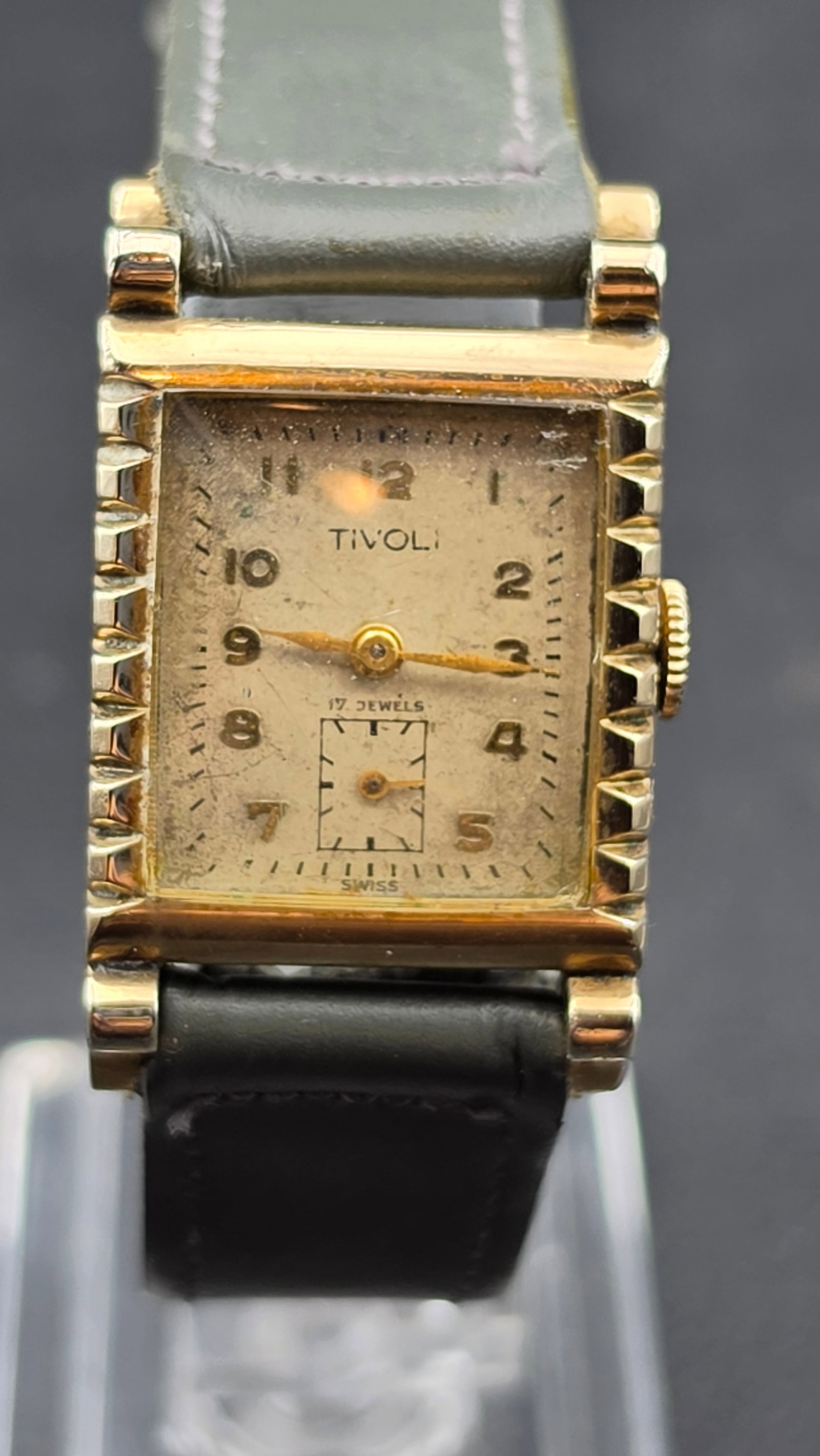 Vintage 1940s Tivoli Art Deco 17 Jewel Manual Wind Watch, Subsidiary Seconds, Swiss: This vintage manual wind wristwatch is signed Tivoli on a rectangular dial with Arabic numerals, a subsidiary seconds register, and the notation 17 Jewels Swiss, set in a case with stepped, fluted lug