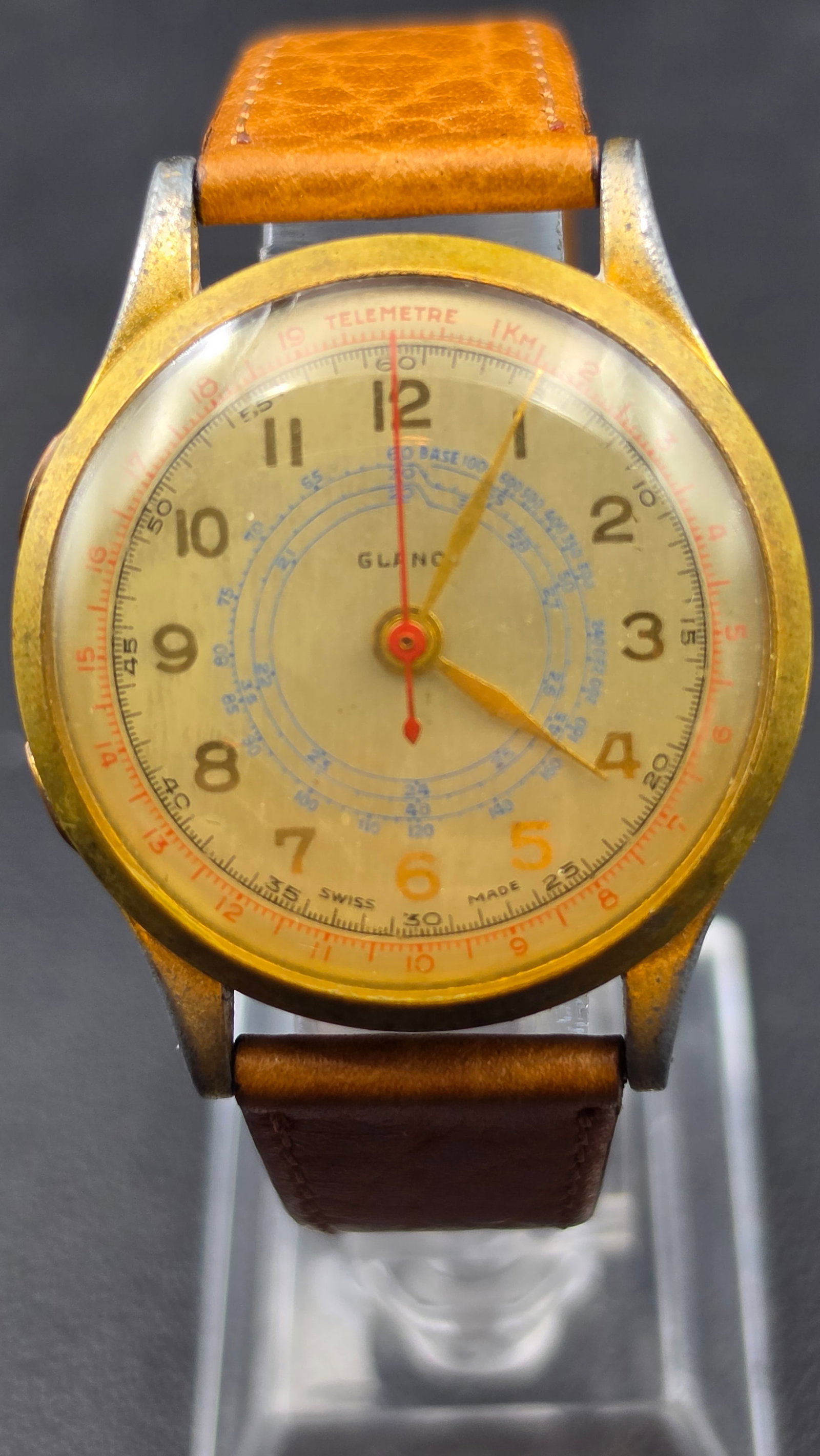Vintage Swiss Glanov Multi-Scale Telemetre Dial Wristwatch Gold Tone Not Running: This vintage wristwatch is signed Glanov on the dial and marked Swiss Made. It features an elaborate multi-scale dial combining an outer telemetre scale (marked Telemetre, 1 KM) with a concentric blue