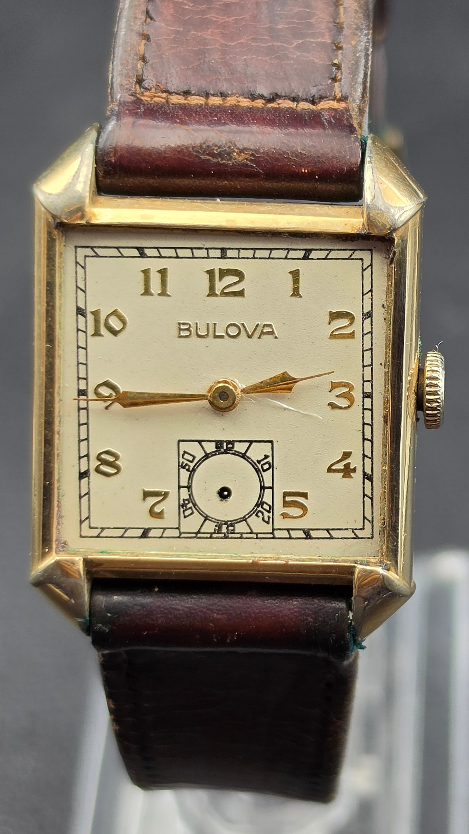 Vintage Bulova 17 Jewels Art Deco Tank Watch, Cal. 10BC, 10K RGP Case, With Box: This is a vintage Bulova Art Deco tank wristwatch with a dial signed "Bulova," featuring gold Arabic numerals at each hour and a subsidiary seconds register at 6, gold dauphine-style hands, and a rect