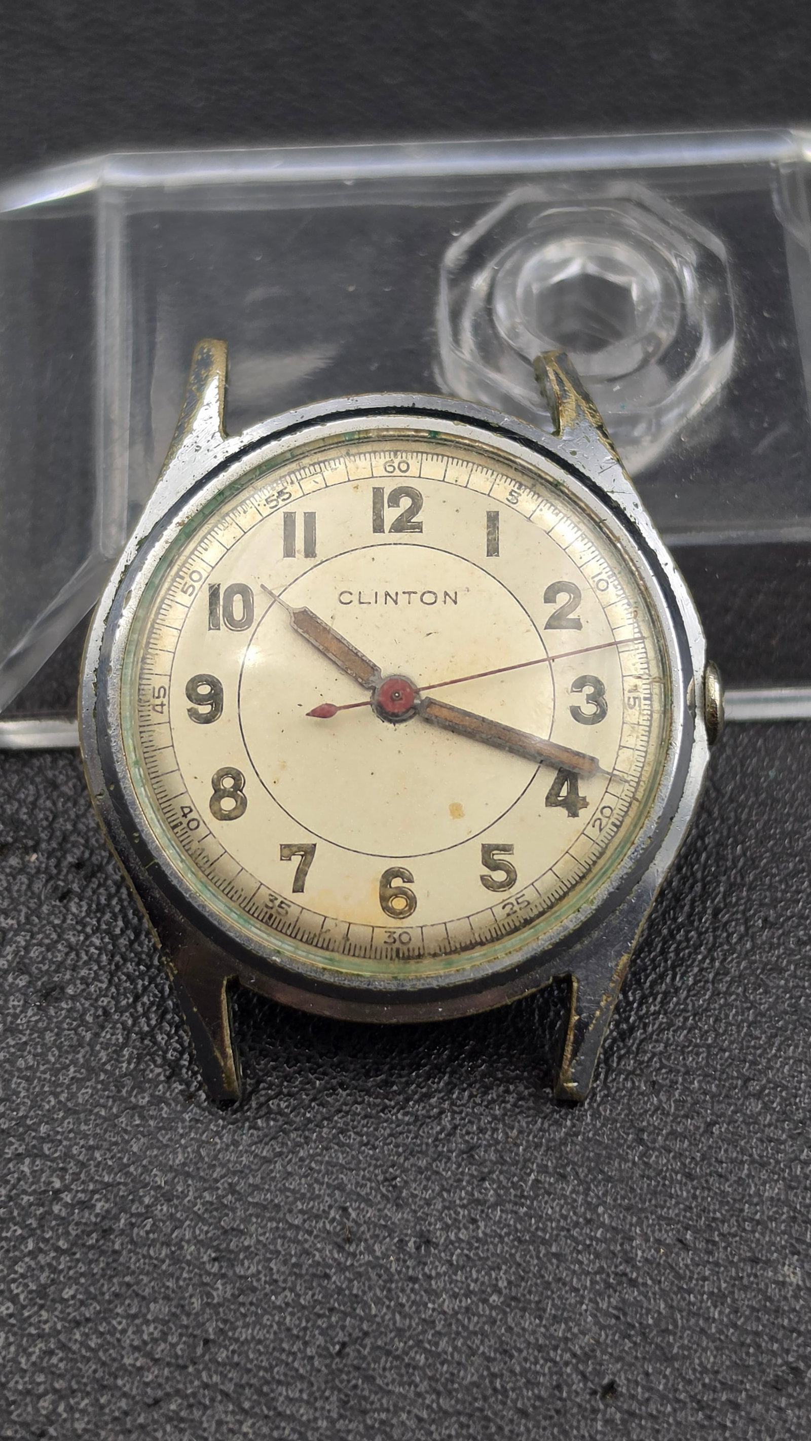Vintage Clinton 7 Jewels Swiss Manual Wind Watch, Holmar Movement, Stainless Case: This is a vintage Clinton manual wind wristwatch with a cream dial signed "Clinton," featuring bold black Arabic numerals, a railroad-style minute track, gold baton hands, and a red sweep second hand.