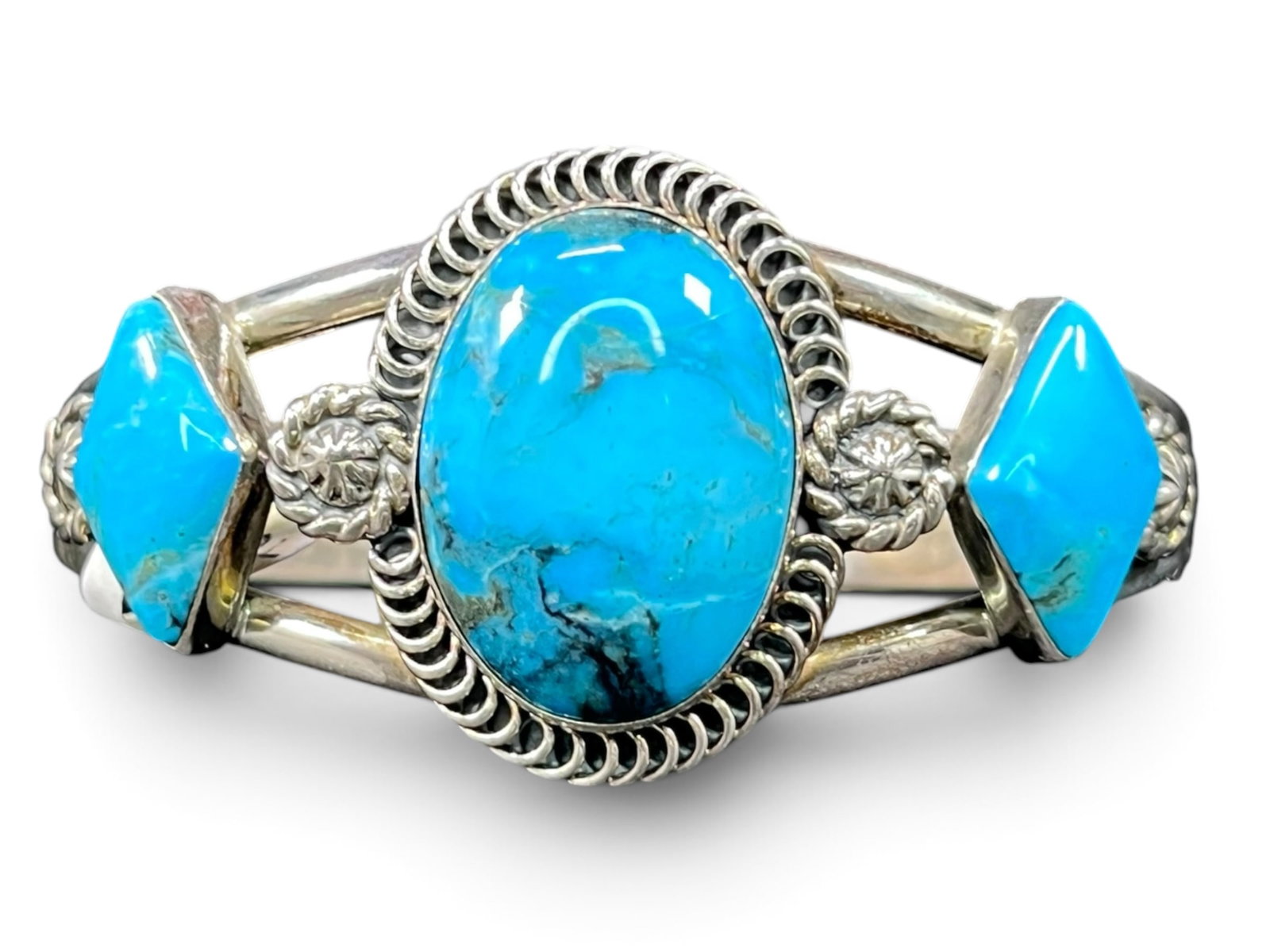 34g Navajo Running Bear 925 Turquoise Three-Stone Cuff Bracelet: Striking Navajo sterling silver cuff bracelet by New Mexico based Running Bear Trading Post, set with three vivid blue turquoise cabochons. The substantial center oval stone is framed by a rope-twist 