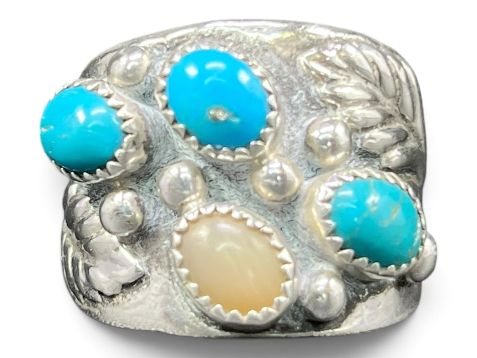 Sz10/11g Navajo Sterling Turquoise Cluster Ring: Handling this ring, its weight and heft come from a wide, saddle-shaped sterling band that tapers as it wraps the finger. The face carries an asymmetric cluster of four cabochons: three oval turquoise