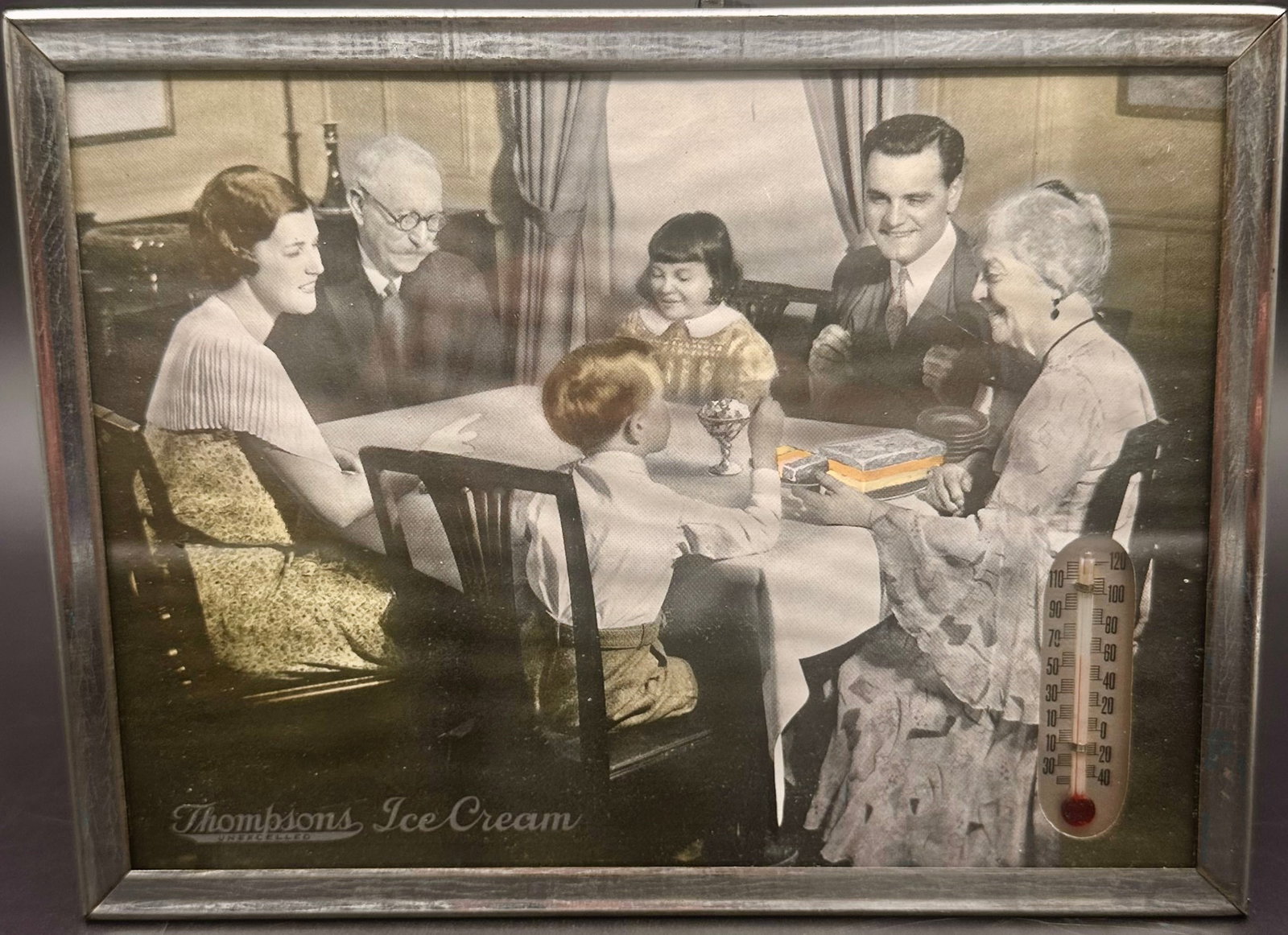Vintage Thompson’s Ice Cream Advertising Picture Frame: Vintage Thompson’s Ice Cream advertising picture featuring a black and white family scene enjoying ice cream. Displayed in its metal frame with Thompson’s Ice Cream logo at the bottom. Measures ap