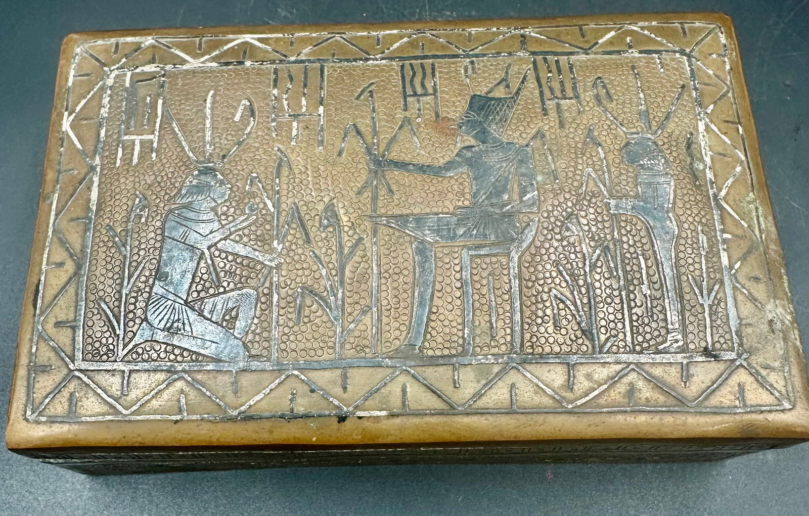 Antique Egyptian Revival Cairoware Inlaid Metal Box: Antique Egyptian Revival Cairoware-style box, likely early 20th century, featuring a brass/copper-tone metal exterior with contrasting silver-tone base-metal inlay, engraved Egyptian figures, hierogly