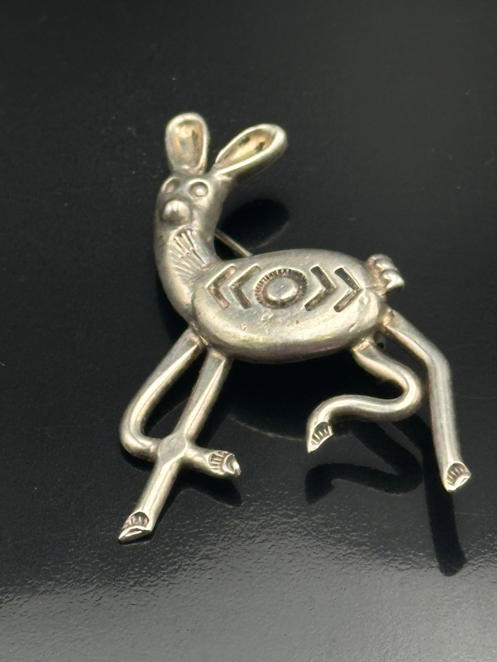 11g Vintage Southwestern Sterling Silver Rabbit Brooch: Vintage sterling silver rabbit brooch with a handmade Southwestern design and geometric details. Nice older patina and unique long-leg rabbit shape. Weighs 11 grams. Good vintage condition with age-re