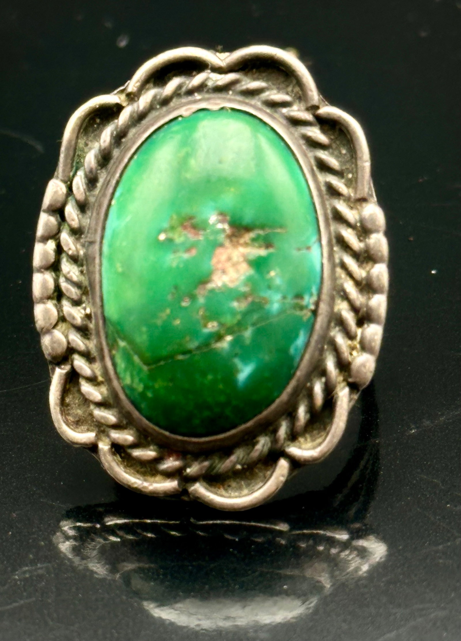 10g Vintage Navajo Sterling Silver Number 8 Turquoise Ring: Vintage Navajo sterling silver ring with a large turquoise stone, believed to be Number 8 Mine turquoise. Beautiful green color with natural brown matrix. Detailed twisted rope and scalloped silver de
