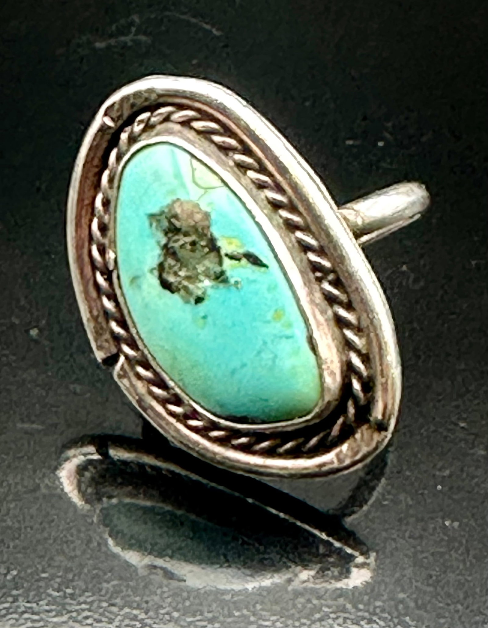 8g Vintage Navajo Sterling Silver Turquoise Rope Edge Ring: Vintage Navajo sterling silver ring with a natural turquoise stone and dark matrix. Rope design around the stone with nice old patina. Weighs 8 grams. Unsigned.