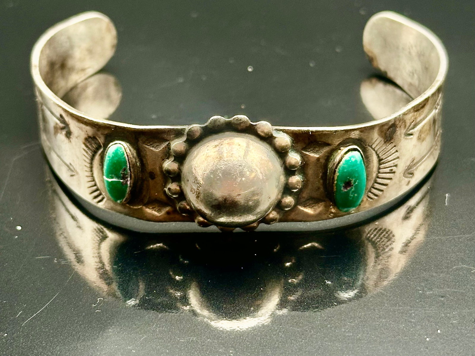 24g Fred Harvey Era Sterling Silver Turquoise Cuff Bracelet: Vintage Fred Harvey era sterling silver cuff bracelet with two turquoise stones, a large silver dome and hand-stamped designs. Marked STERLING. One turquoise stone has a crack. Shows vintage wear and 