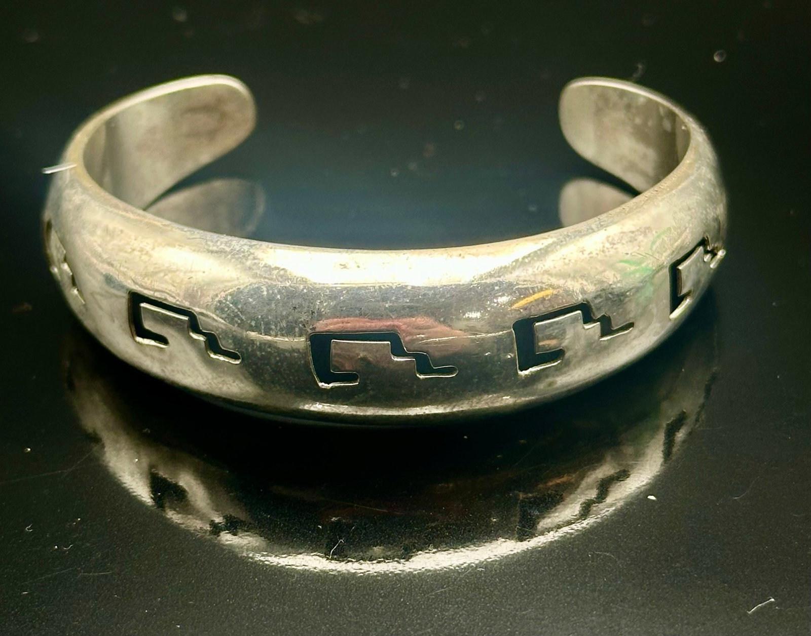 17g Vintage Mexico Silver Geometric Cutout Cuff Bracelet: Vintage Mexican silver cuff bracelet with geometric cutout designs. Marked MEXICO with no sterling or 925 mark visible. Shows vintage wear, scratches and tarnish. Weighs 17 grams.