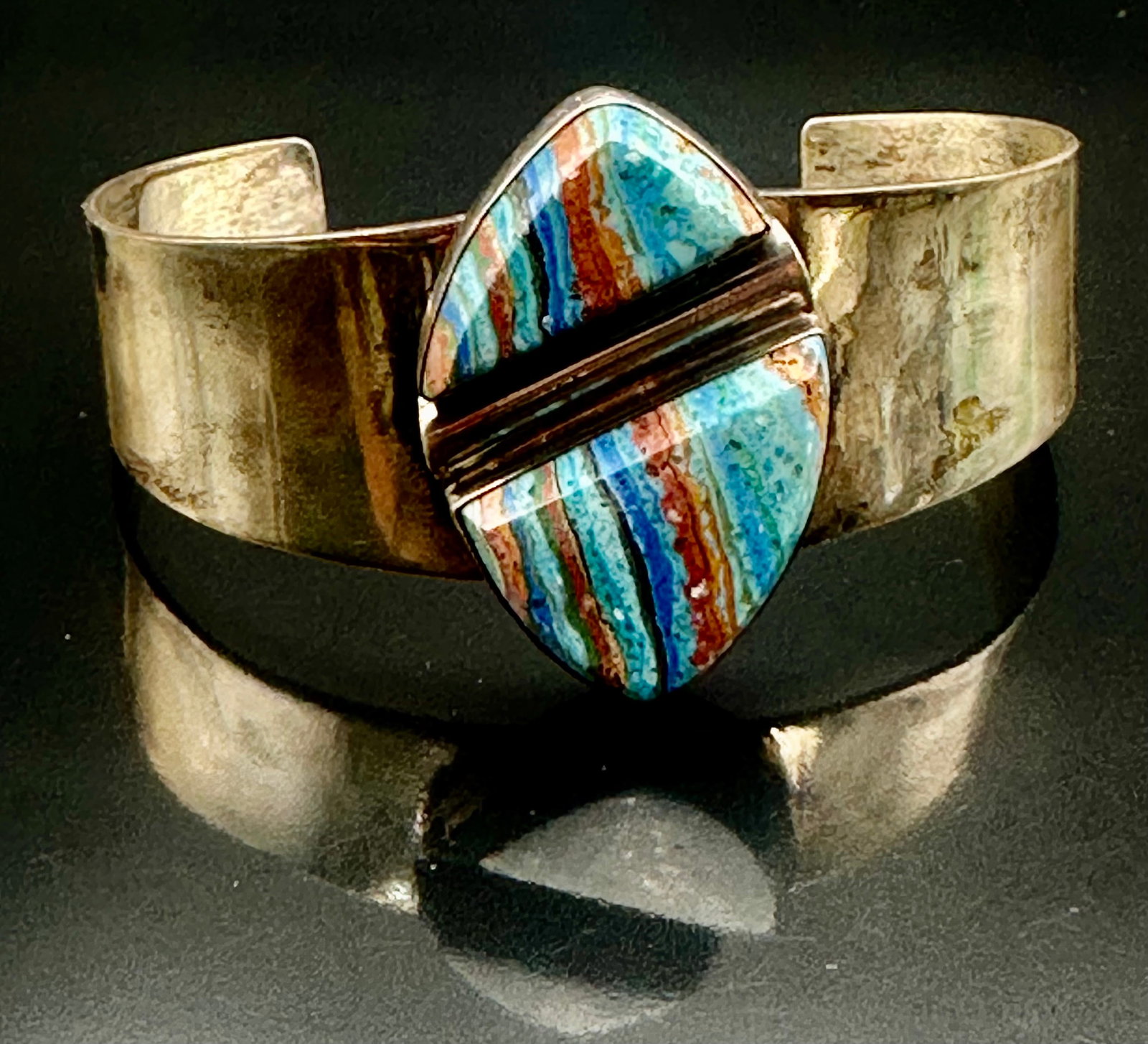 42g DTR Sterling Silver Rainbow Calsilica Cuff Bracelet: Wide sterling silver cuff bracelet with a large colorful rainbow calsilica stone. Modern geometric design with a polished finish. Marked DTR, China and 925. Weighs 42 grams. Shows some wear and tarnis