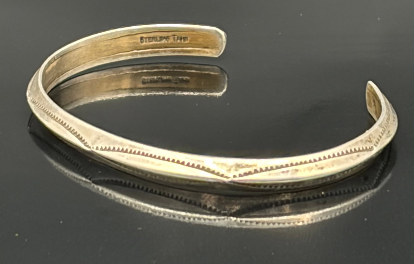11.5 Vintage Navajo Stamped Design Stacker Stackable Sterling Cuff Bracelet: This vintage Navajo cuff bracelet is a stunning piece of jewelry that showcases the beautiful craftsmanship of Native American jewelry makers. Made of 925 sterling silver with a stamped design, it is 